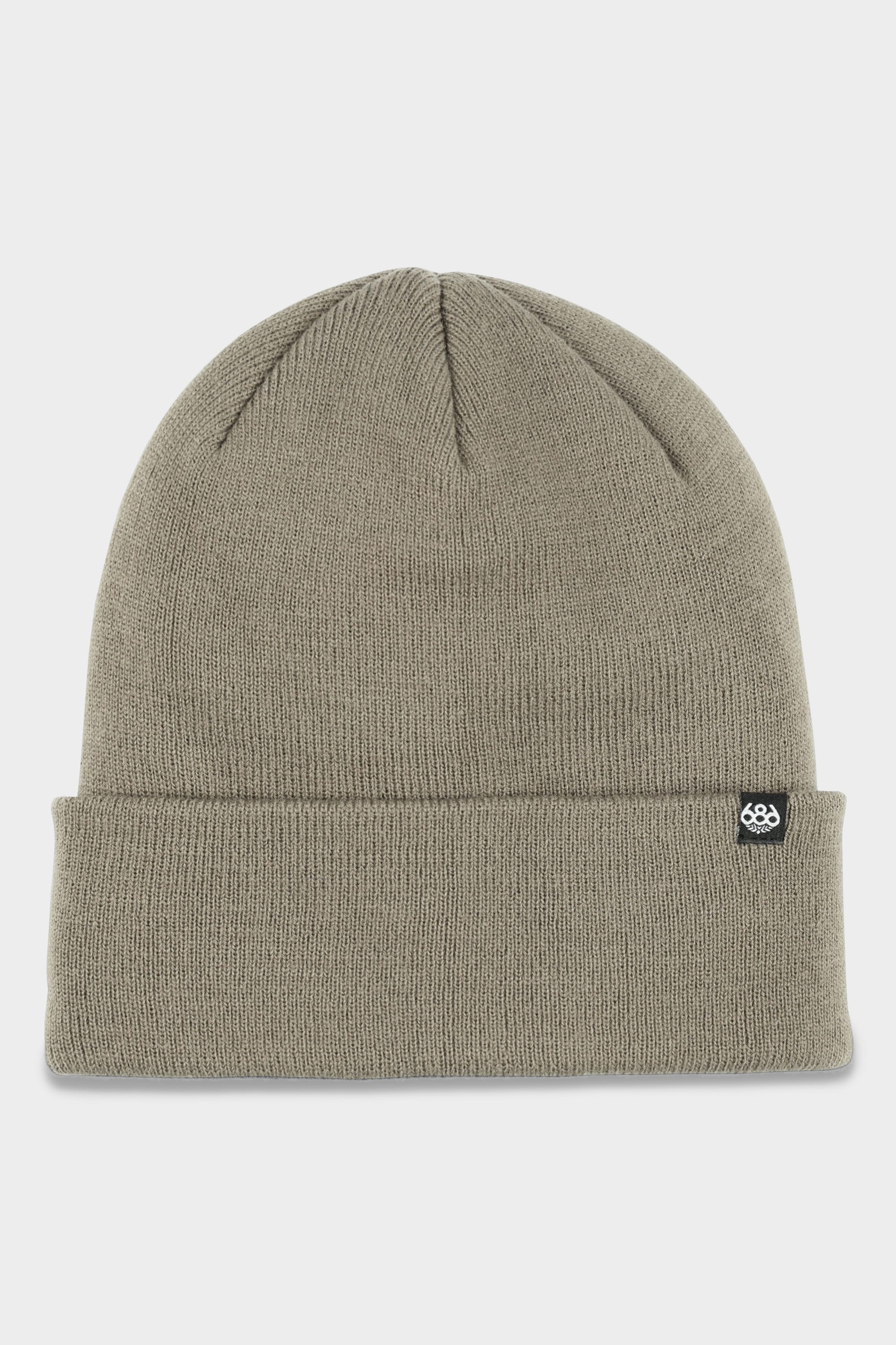 The 686 Standard Roll Up Beanie by 686 is a light olive green knit hat with a folded brim and a small black fabric tag featuring a white logo on the side, displayed against a plain white background.