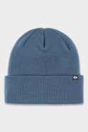 The 686 Standard Roll Up Beanie by 686 is a blue knit beanie featuring a folded brim and a small black logo patch on the left cuff, shown on a white background.