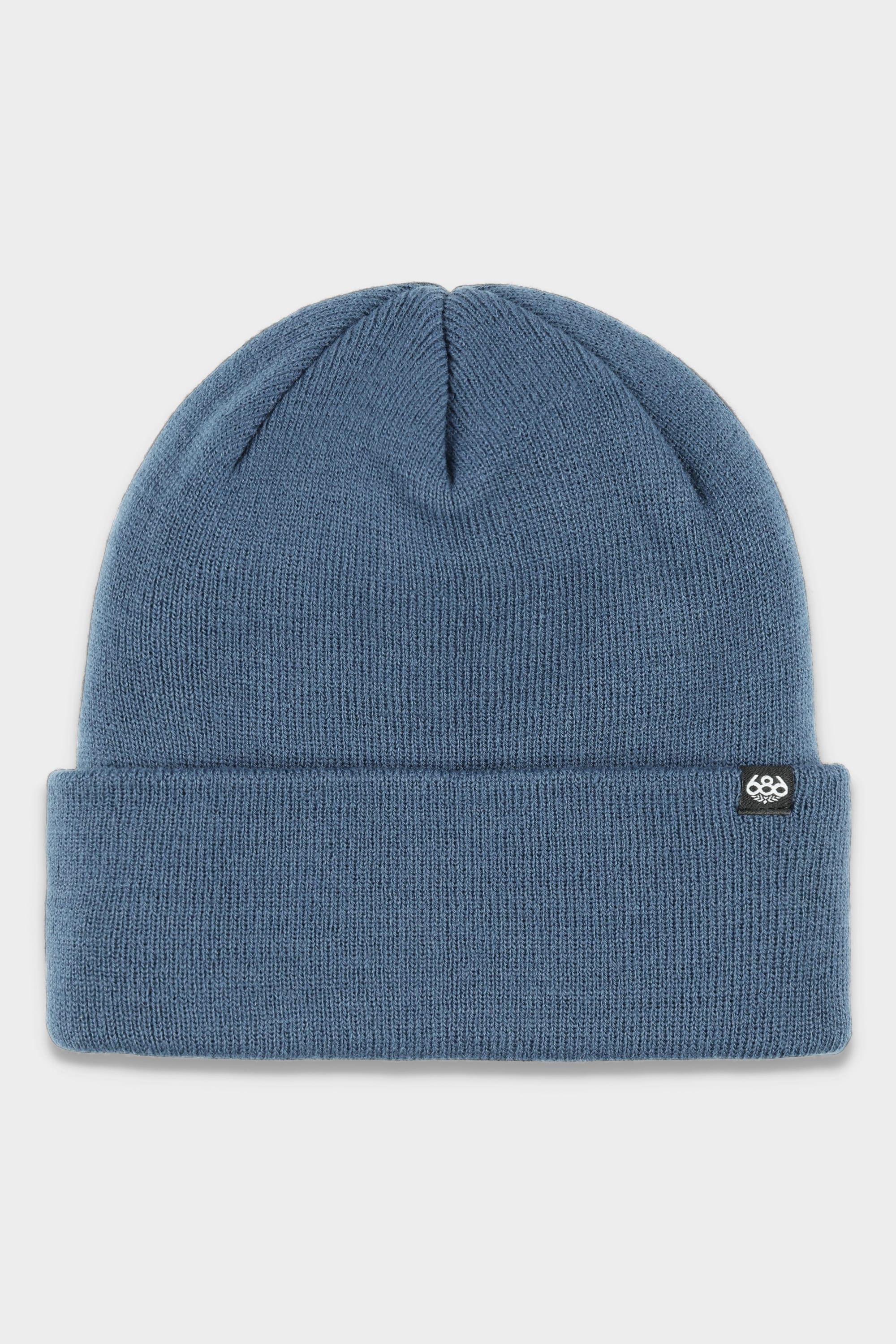 The 686 Standard Roll Up Beanie by 686 is a blue knit beanie featuring a folded brim and a small black logo patch on the left cuff, shown on a white background.
