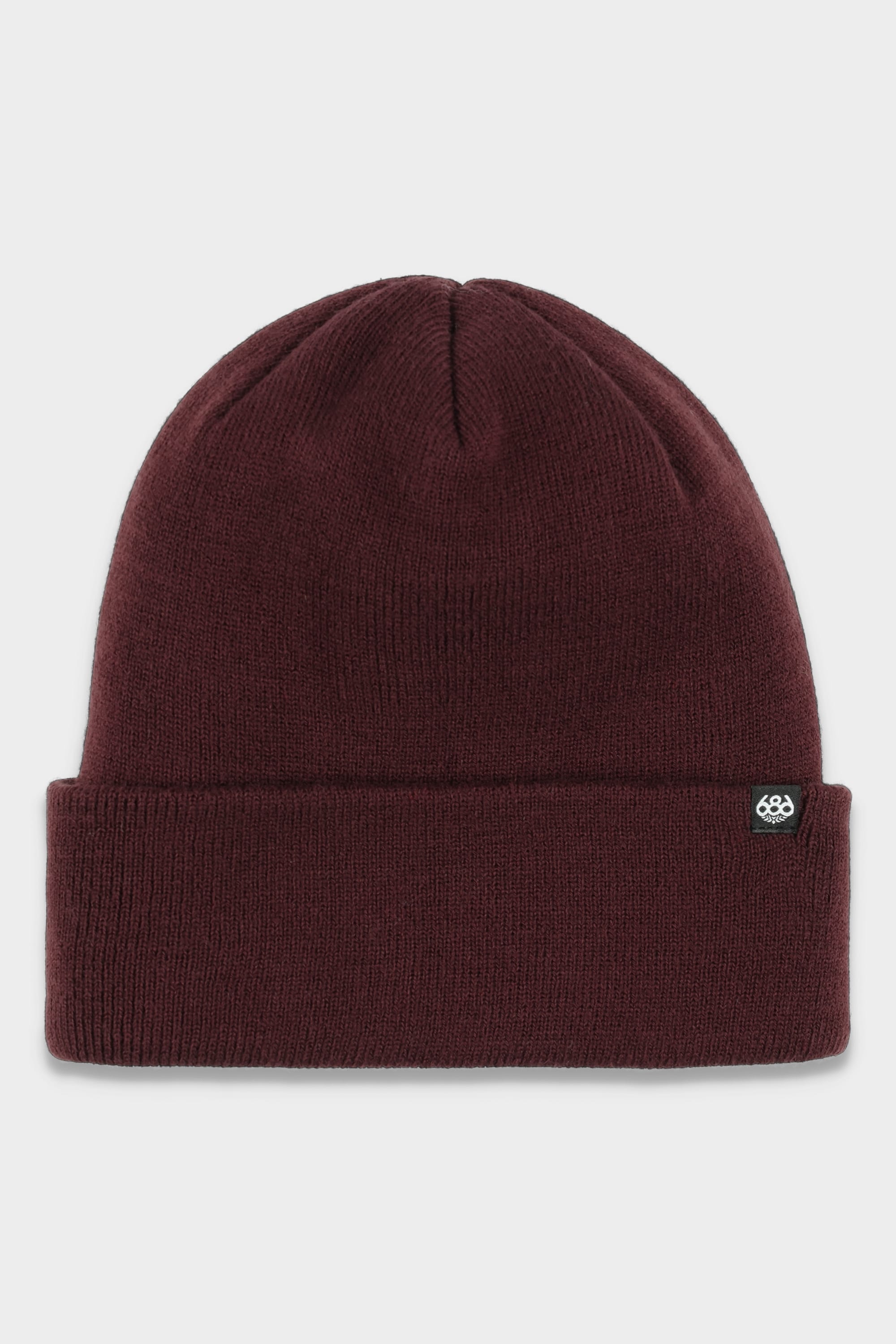 The 686 Standard Roll Up Beanie by 686 is a maroon knit hat with a standard folded brim and a small black tag with a white logo on the side, shown on a plain white background.