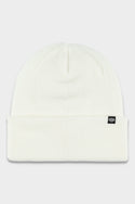 The 686 Standard Roll Up Beanie by 686 is a classic white knit hat with a folded brim and a small black tag featuring a white logo on the front, shown against a light gray background.
