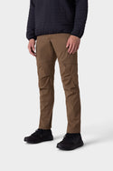 A person wearing a black quilted jacket, 686 Men’s Anything Cargo Pant - Slim Fit, and black sneakers stands against a plain white background.