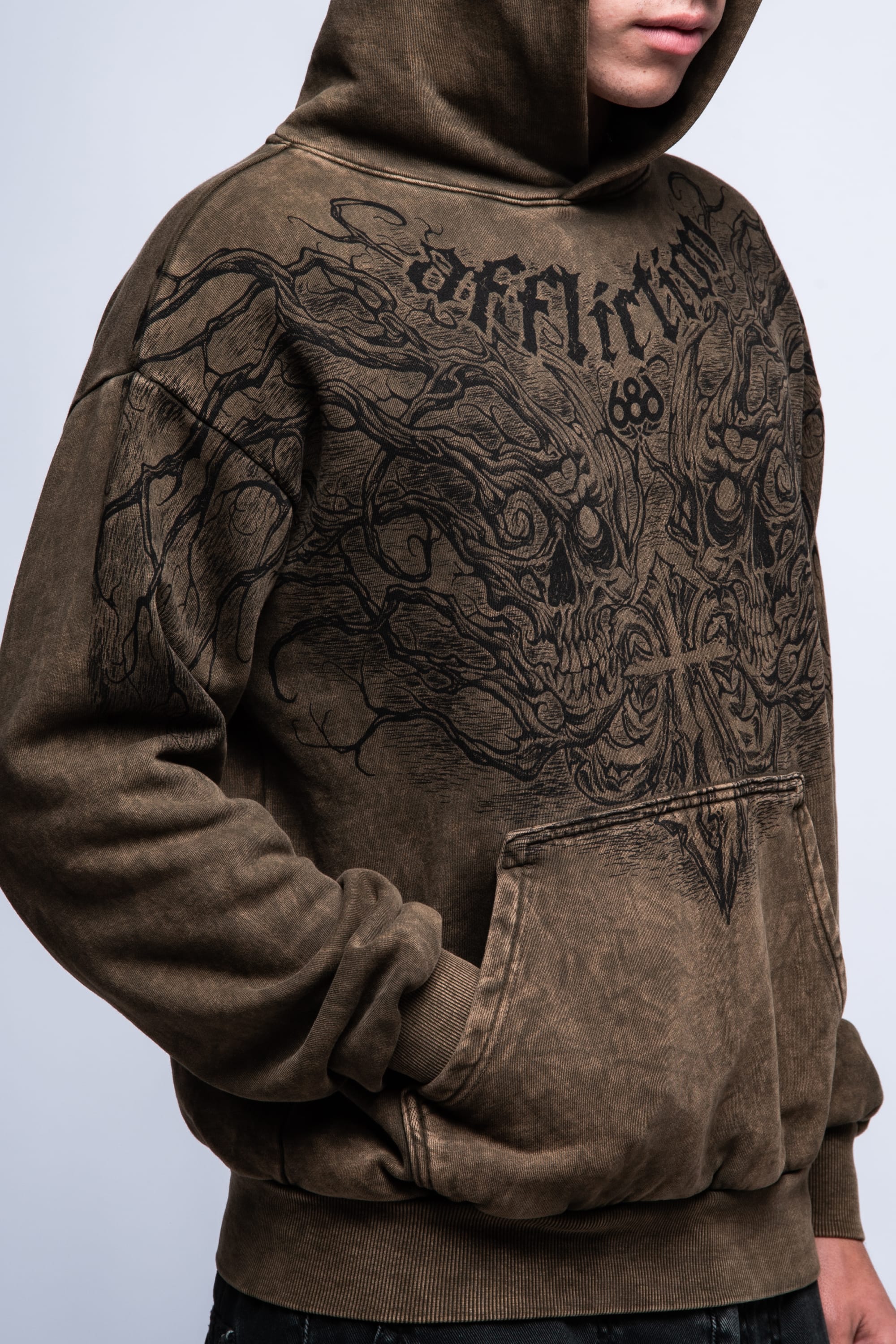A man wears the 686 Affliction Natural Rot Pullover Hoody—a brown, cotton sweatshirt featuring a large black graphic and "Affliction" on the chest. The image shows his upper body with face partially out of frame. Brand: 686.