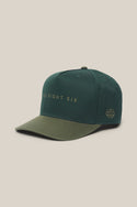 A green 686 High-Pro Ses Two Tone Structured 5 Panel Hat made from cotton, featuring the SIX EIGHT SIX branding on the front and a small embroidered logo on the side, displayed against a light background.