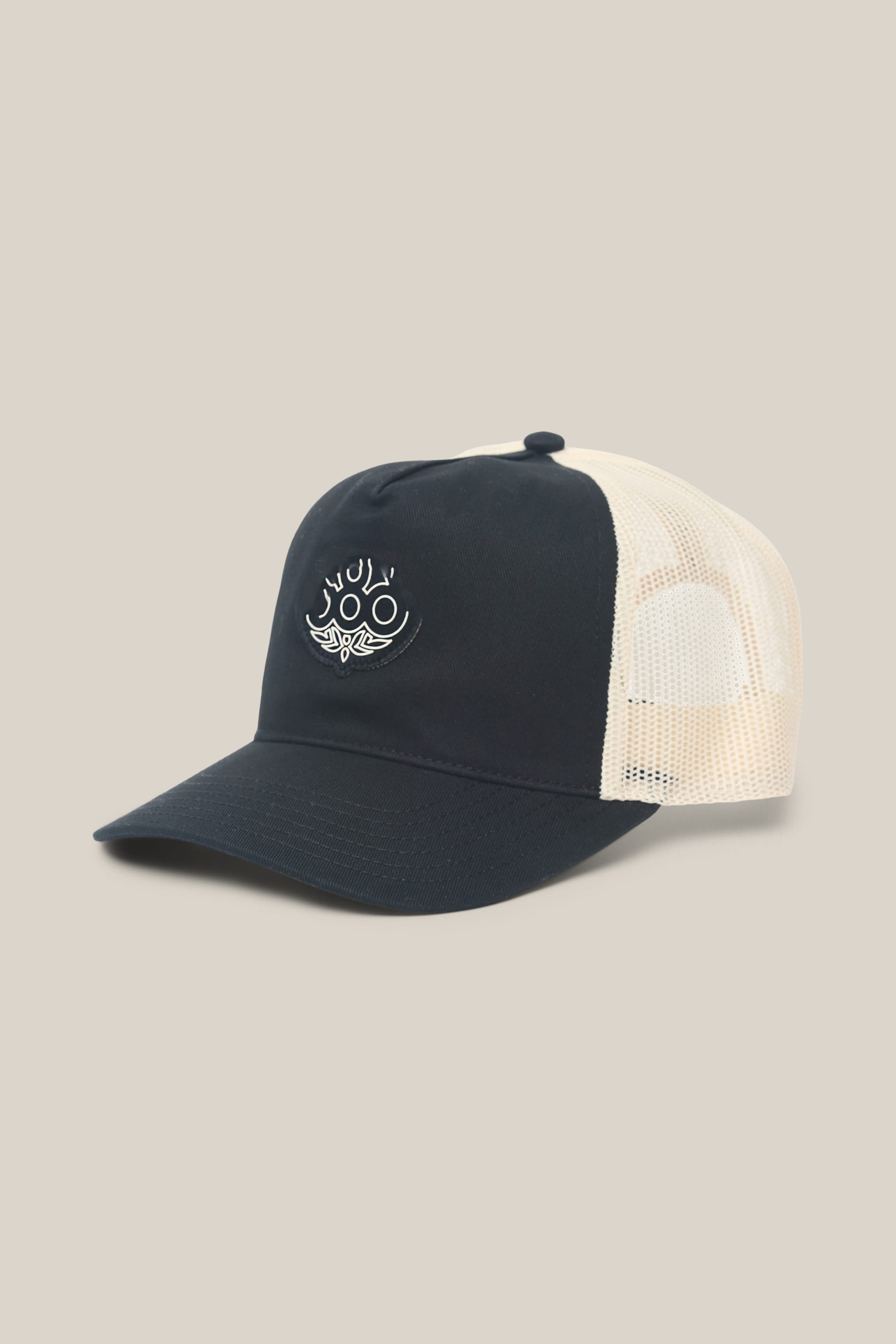 The 686 Mid-Pro Wreath Unstructured 5 Panel Mesh Hat by 686 is a navy blue and beige men's trucker hat, crafted from polyester cotton. It showcases a white embroidered graphic of eyes and a wave on the front, and features a stylish woven design with breathable mesh panels for all-day comfort.