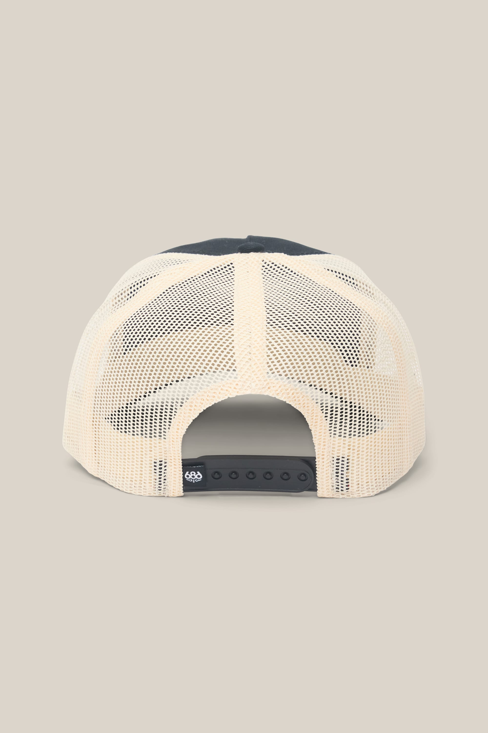 The 686 Mid-Pro Wreath Unstructured 5 Panel Mesh Hat by 686 is displayed from the rear, featuring a beige mesh back, an adjustable snapback closure, and a dark blue upper section against a plain light background. Crafted from a breathable polyester-cotton blend, this men's hat combines comfort and style for everyday wear.