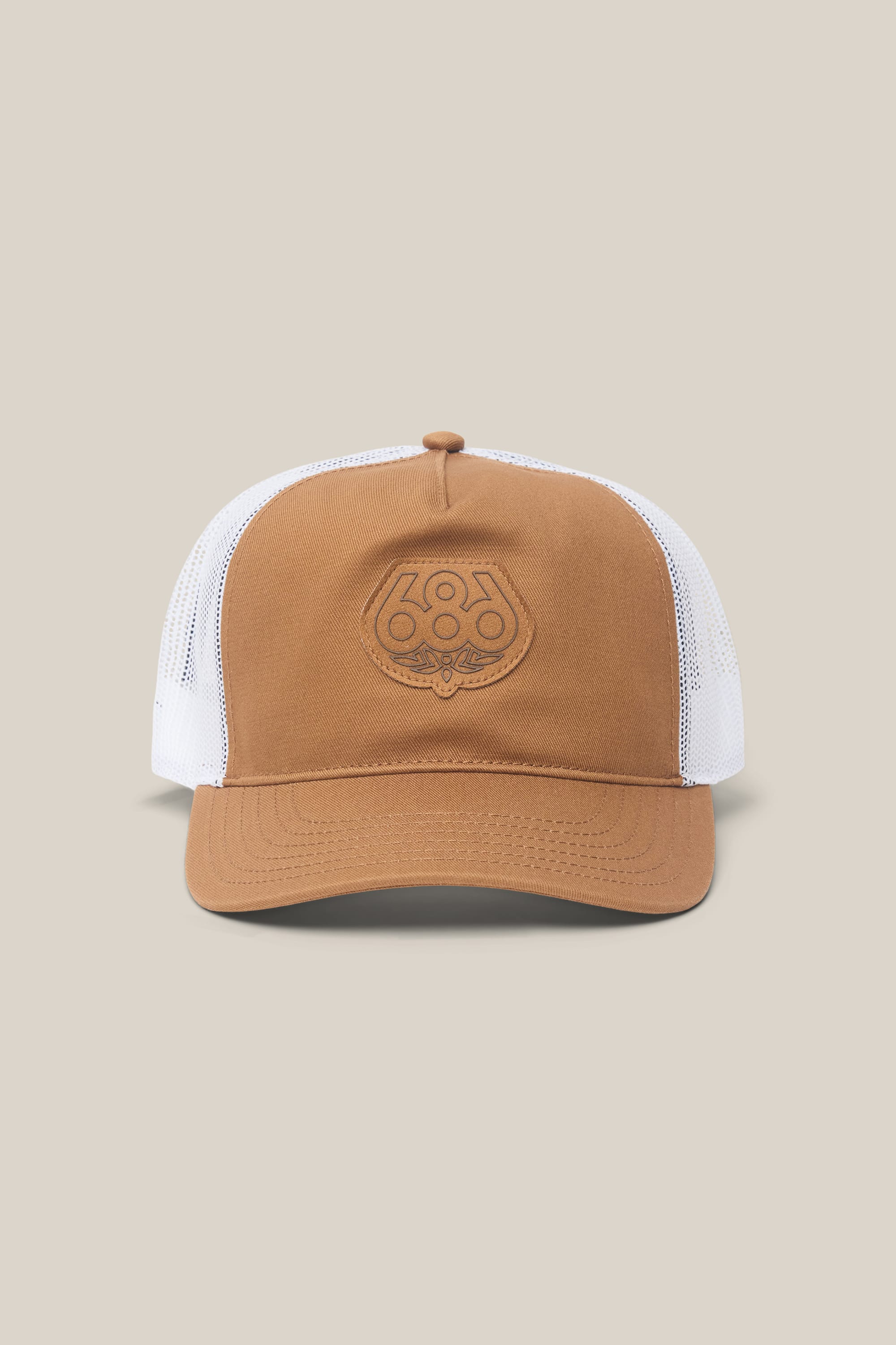 The 686 Mid-Pro Wreath Unstructured 5 Panel Mesh Hat by 686 is a brown and white polyester-cotton woven hat in a classic trucker style, featuring a mesh back and an embroidered logo on the front panel. Displayed on a plain beige background, this men's hat offers casual comfort with timeless design.