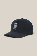 The 686 Mid-Pro Ghost Cord Unstructured 5 Panel Hat by 686 is a men's black corduroy baseball cap with a curved brim and a white embroidered logo of two vertical lines, shown against a plain beige background.