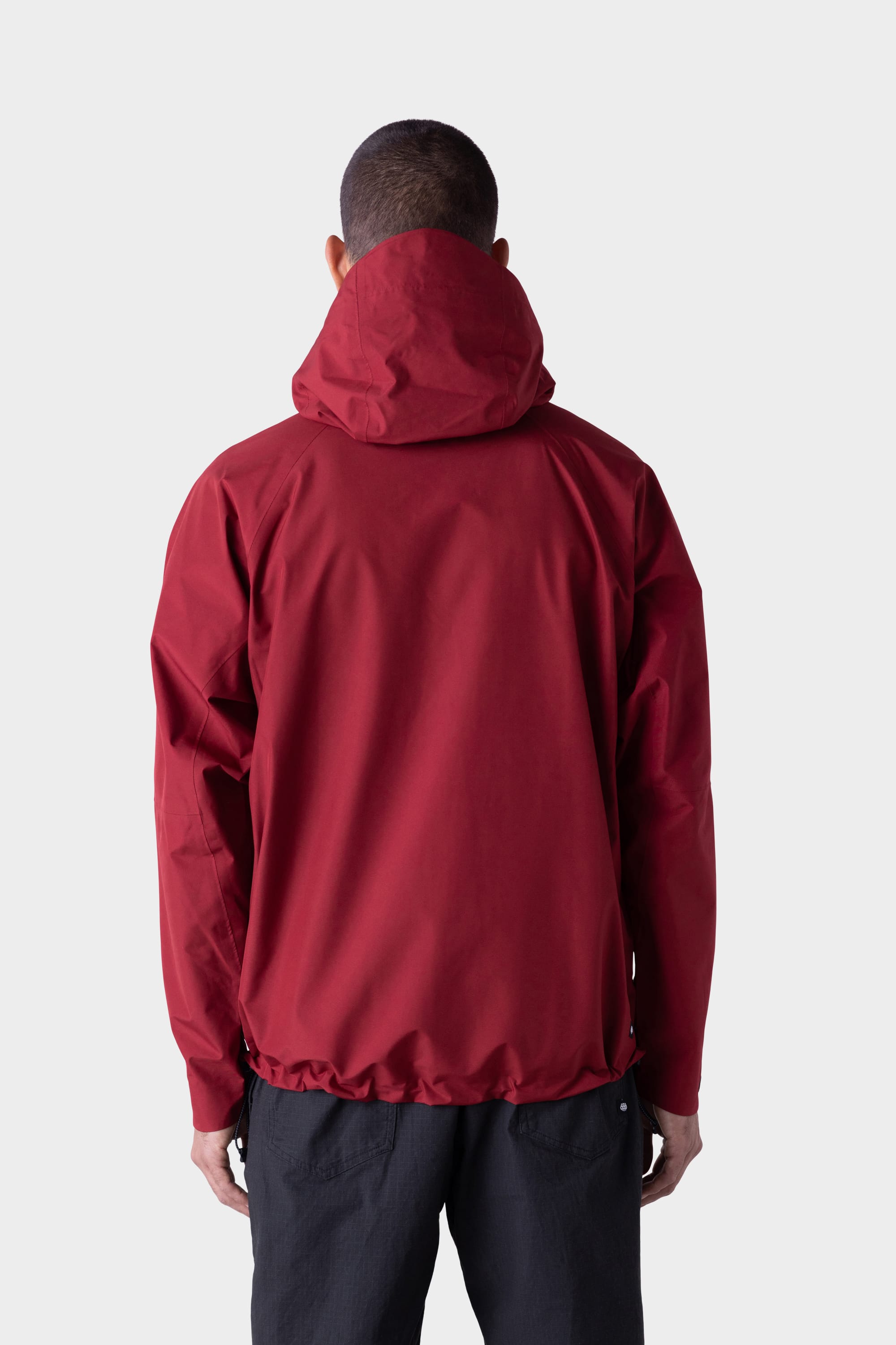 A person wearing the 686 Mens GORE-TEX PACLITE® Jacket and black pants is shown from behind, standing against a plain white background.