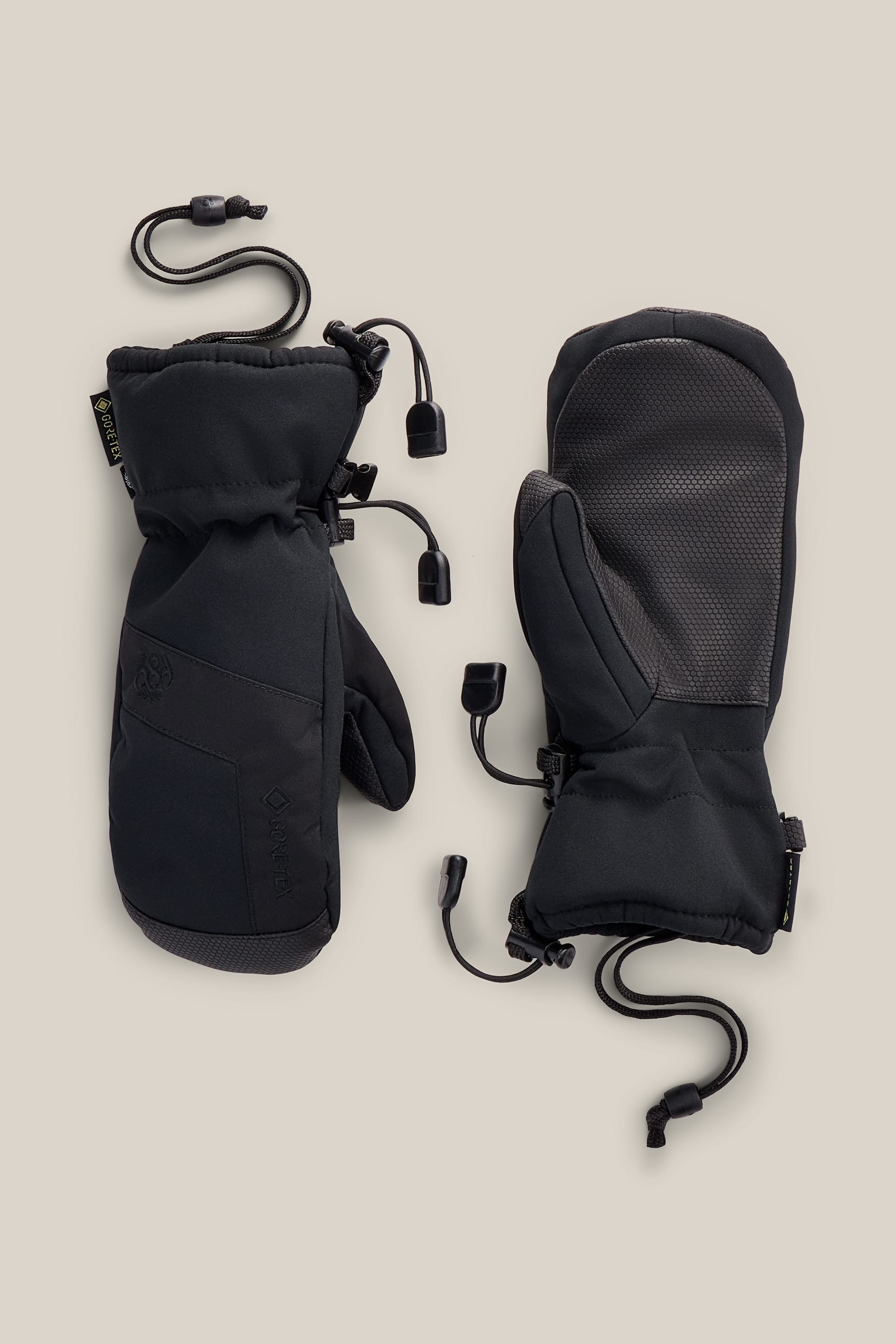 A pair of 686 Youth GORE-TEX® Linear™ Mitts are laid out on a neutral background, displaying both the back and palm sides and featuring cinch cords with adjustment toggles.