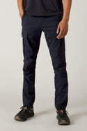 A person wearing black athletic shoes, a black shirt, and 686 Men's Anything Cargo Pant - Slim Fit by 686 with a 13-pocket design stands against a light background; only their lower half is visible—ready for any adventure.