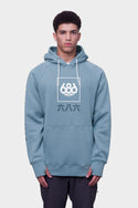 A young man wears the 686 Mens Script Knockout Hoody in light blue, featuring a white 686 logo and stylized numbers on the front, standing against a plain light grey background.