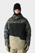 A person wears the 686 Mens Geo Insulated Jacket by 686, featuring a geometric camo pattern and black details, along with a black beanie, black neck gaiter, and beige gloves, facing forward against a plain light background.