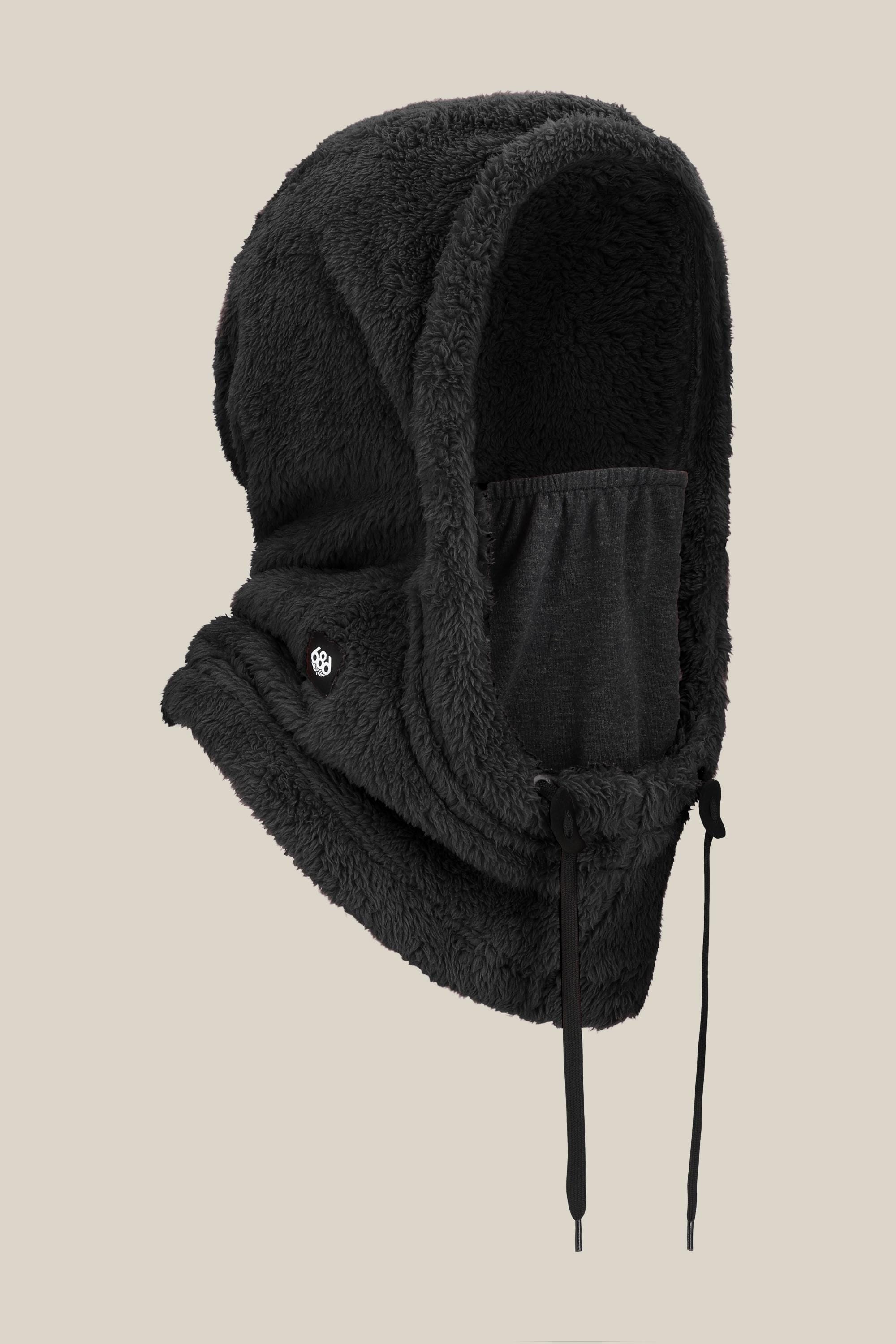 The 686 Tarmac Fleece Hood by 686 is a black, fleece-lined balaclava with an adjustable drawstring and face covering—ideal as a hoodie accessory—shown on a beige background.