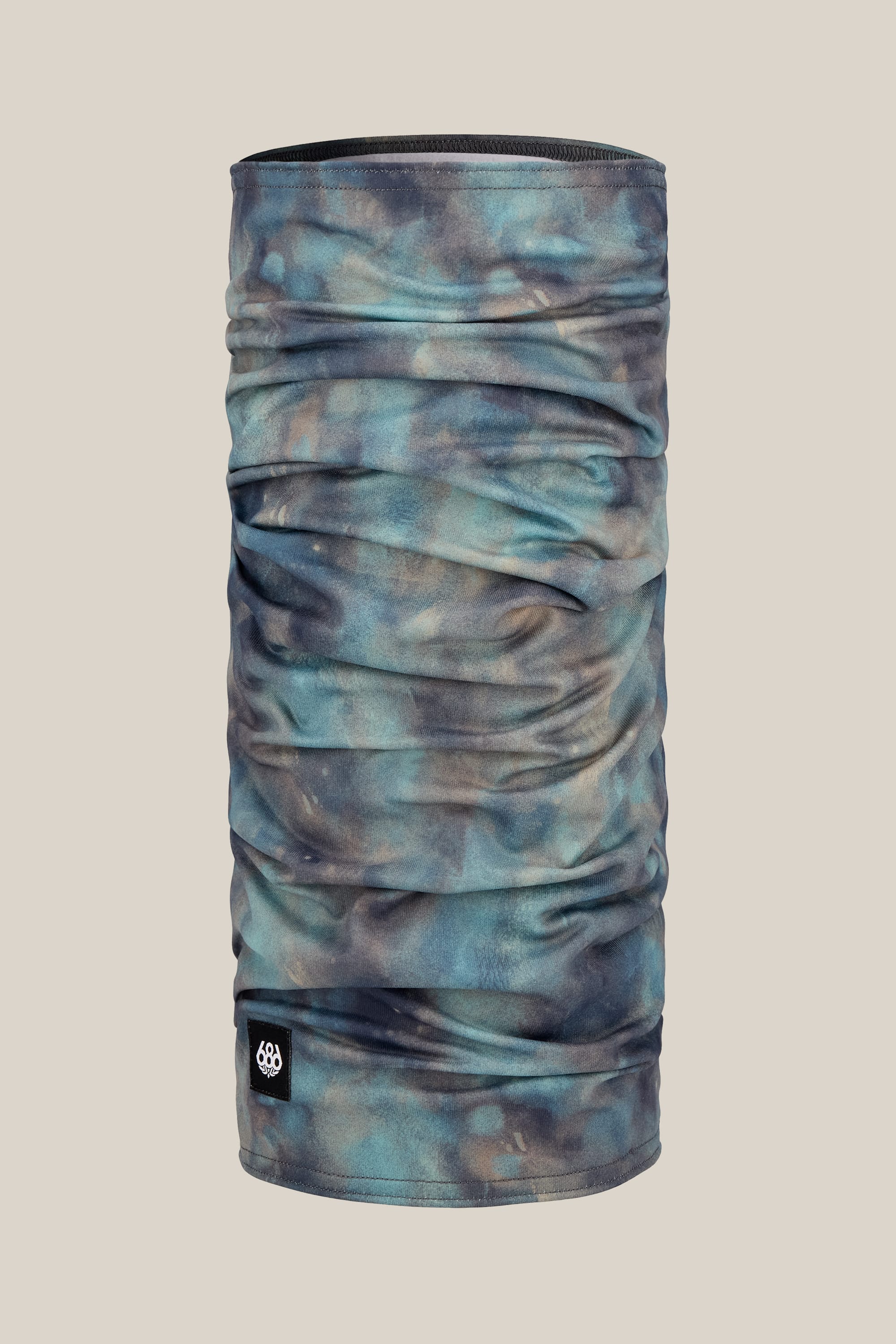 The 686 Double Layer Face Warmer by 686 is shown upright against a plain beige background, featuring a blue and brown marbled design with a small black logo tag at the bottom front.
