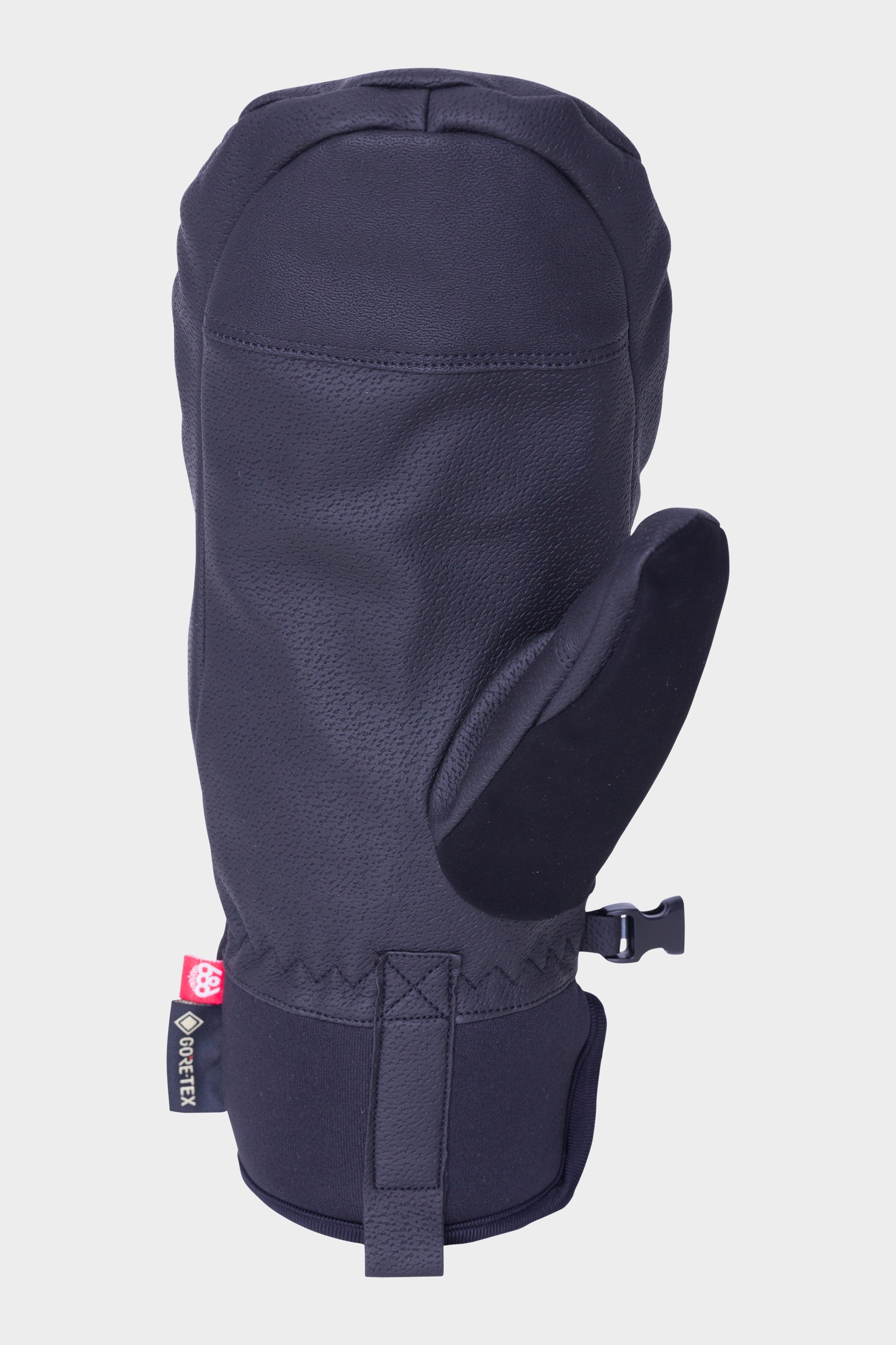 The 686 Mens GORE-TEX Linear Under Cuff Mitt by 686 is a black, insulated mitt with a textured surface, wrist clip, small GORE-TEX tag for waterproofing, displayed against a white background.