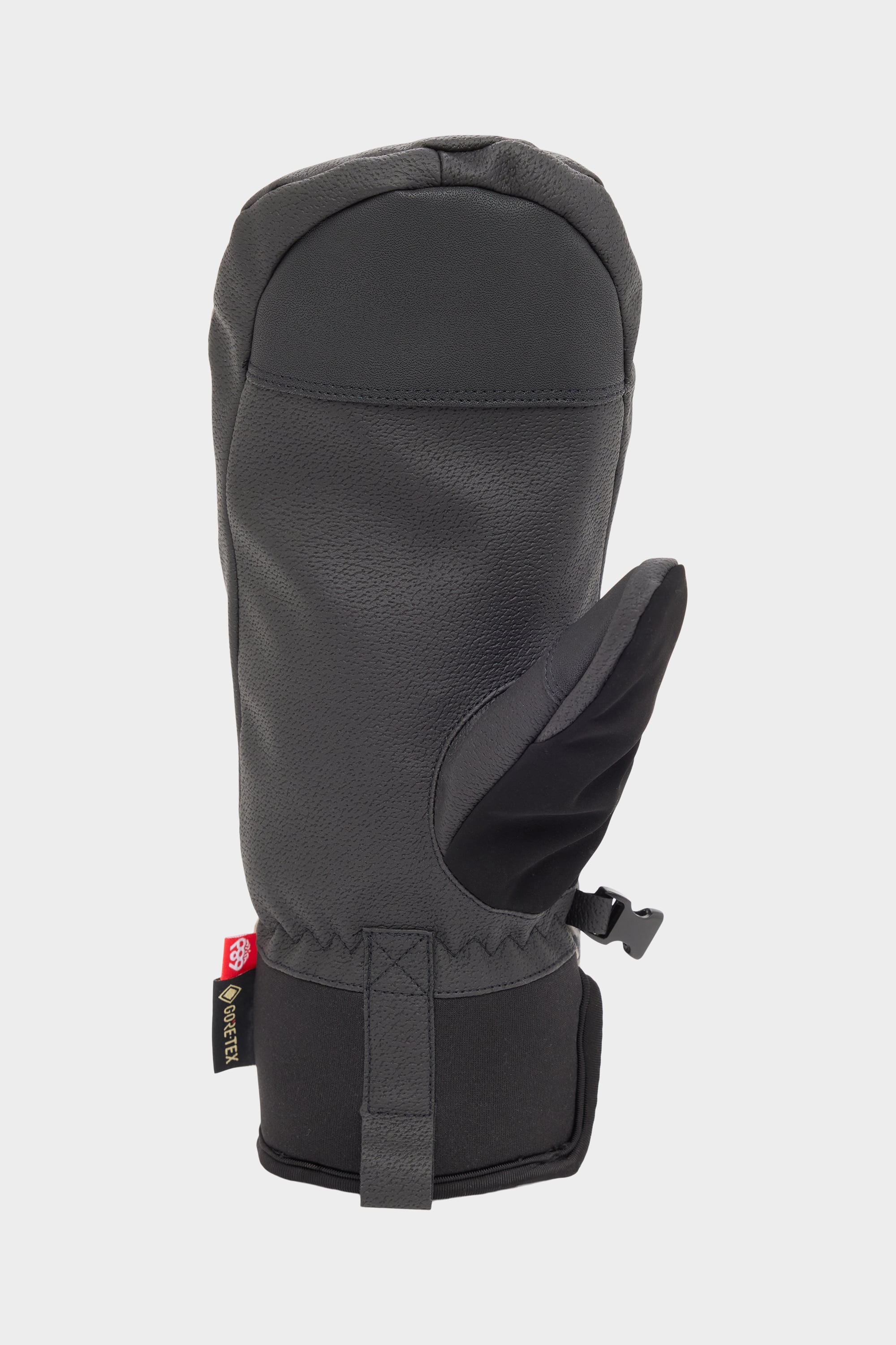 The 686 Mens GORE-TEX Linear Under Cuff Mitt by 686 is a black insulated mitt with waterproofing, textured surface, adjustable wrist strap, and a small red and black side tag, shown against a white background.