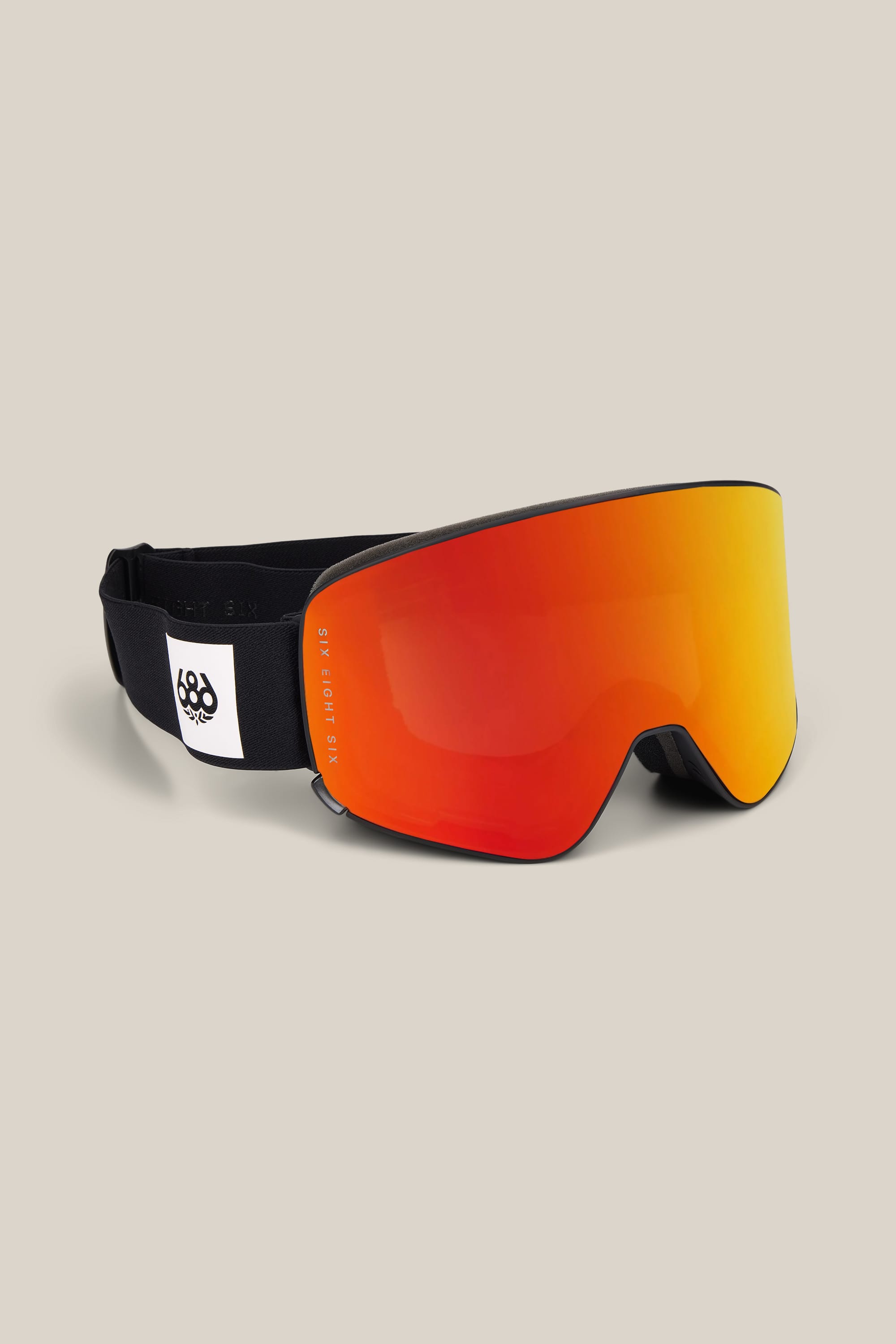 The 686 SMARTY® Magnetic Goggle by 686 features a black strap and a large red-orange mirrored lens, showcased on a neutral background.