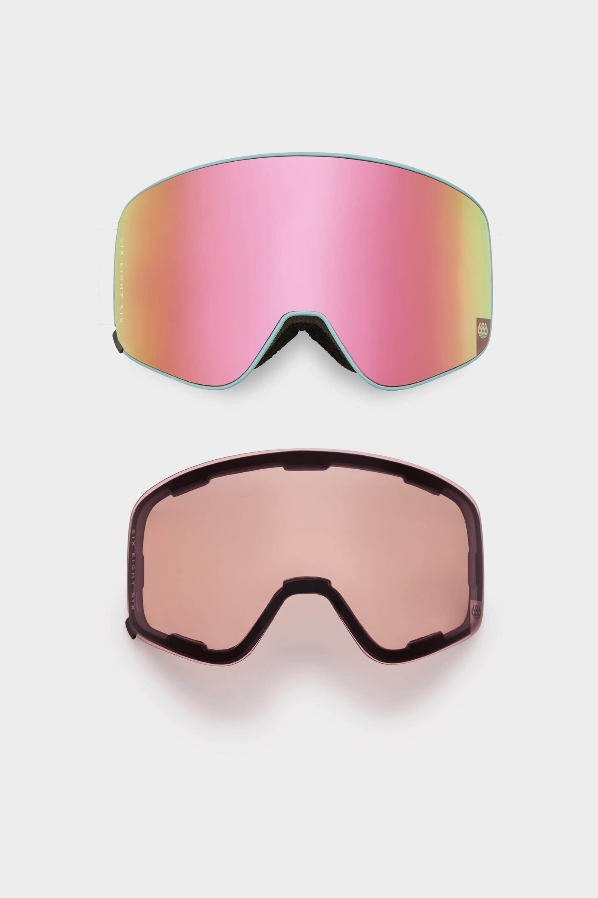 Two pairs of 686 SMARTY Goggles by 686 are shown on a white background: one with a pink reflective magnetic lens and the other with a rose-tinted transparent magnetic lens, allowing for easy swaps in all conditions.