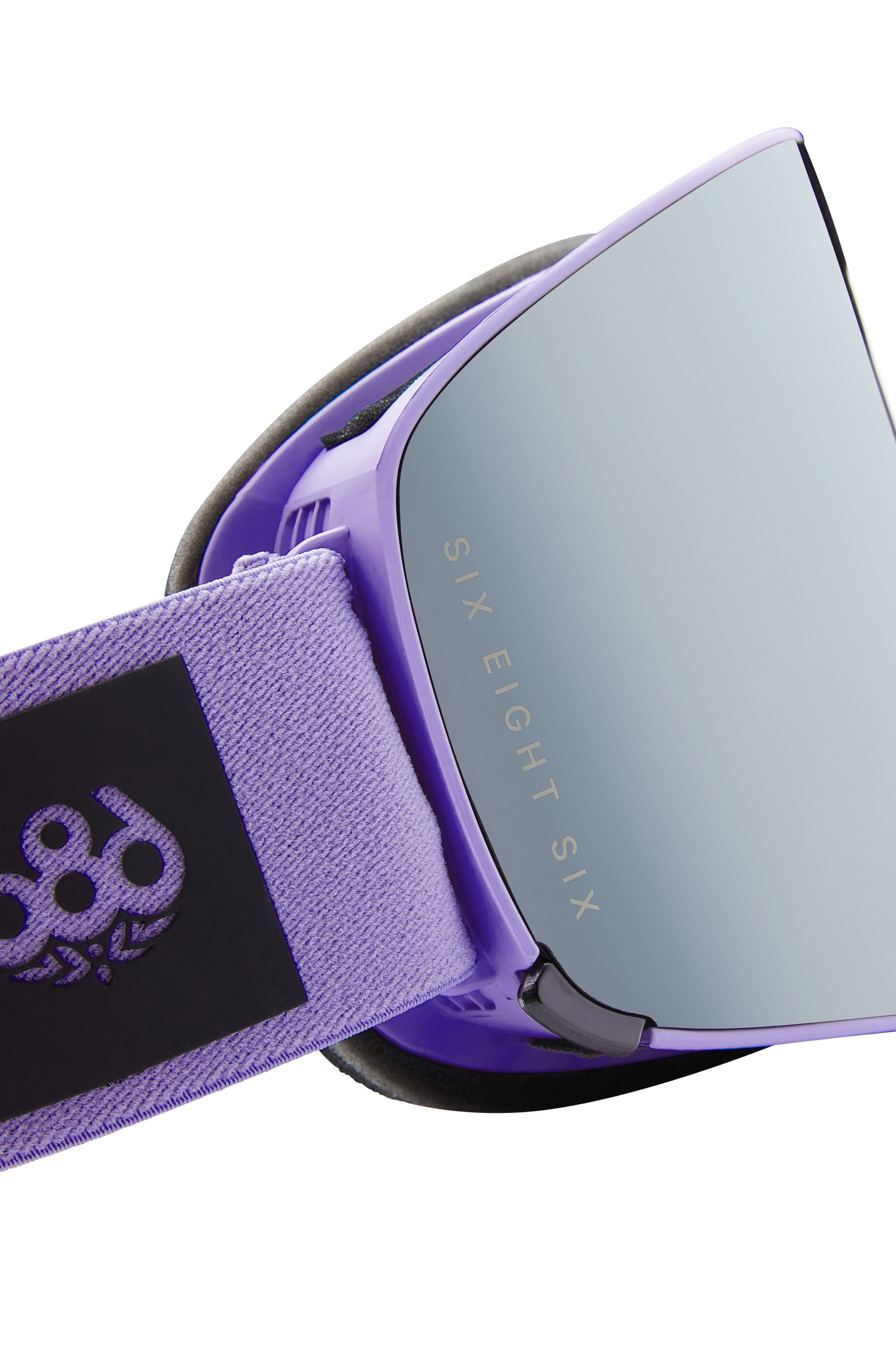 Close-up of the 686 SMARTY Goggle in purple featuring reflective magnetic lenses with the 686 brand, plus an adjustable strap sporting a black patch and white 686 logo—designed for style and clarity in any conditions.