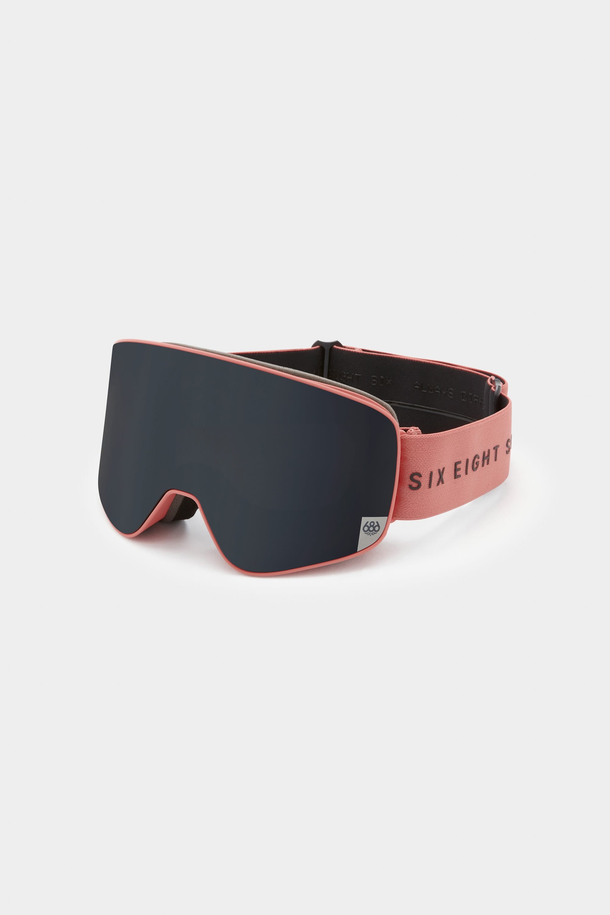 The 686 SMARTY Goggle by 686 features a dark, wide magnetic lens and a pink frame. The adjustable pink strap displays SIX EIGHT in black. Sleek and minimalist, the goggles are shown on a plain white background.