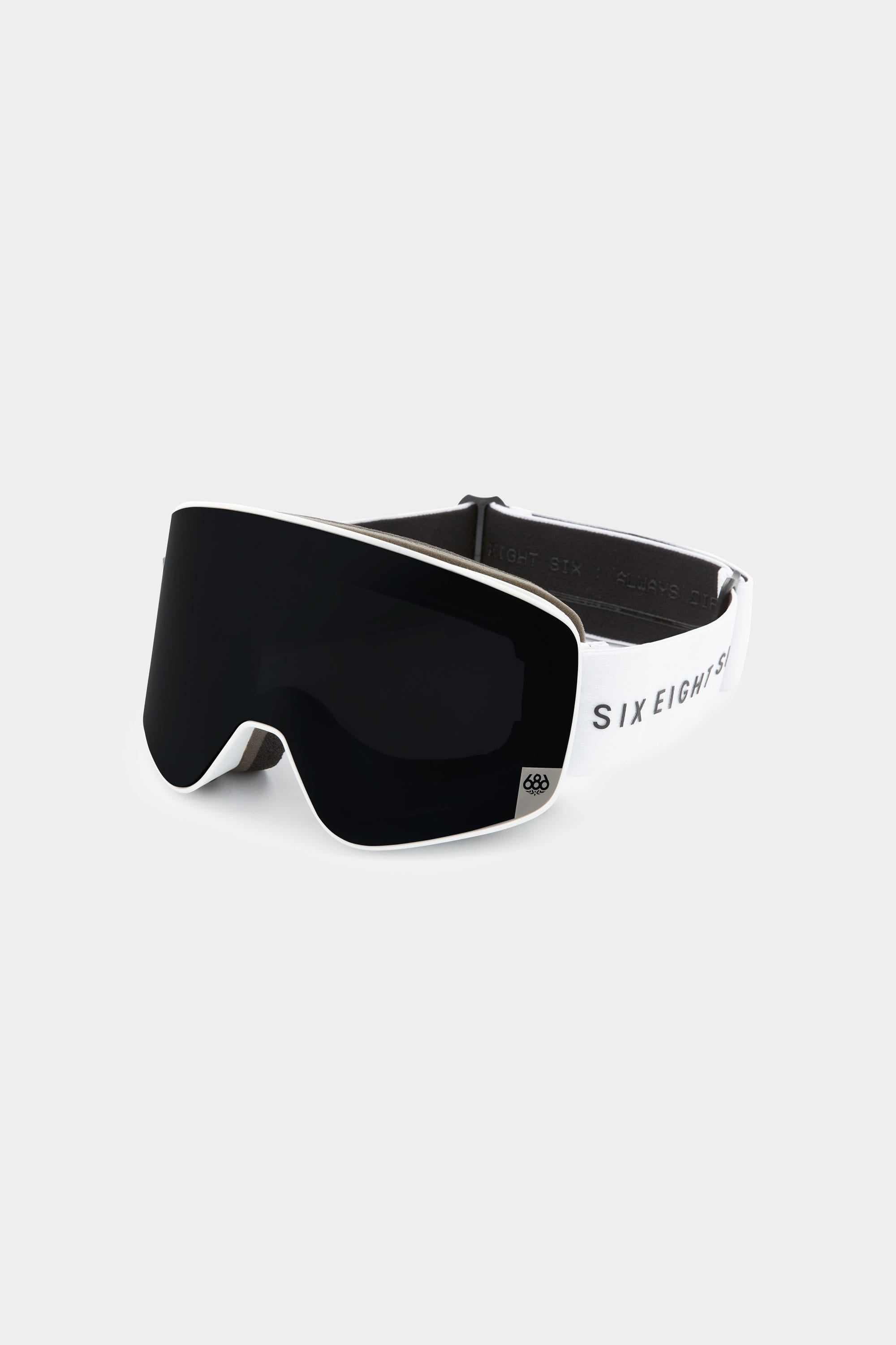 The 686 SMARTY Goggle by 686 features a sleek black lens, white frame, and black strap with bold SIX EIGHT SIX lettering. These minimalist goggles offer modern style plus magnetic lenses suited for all conditions.
