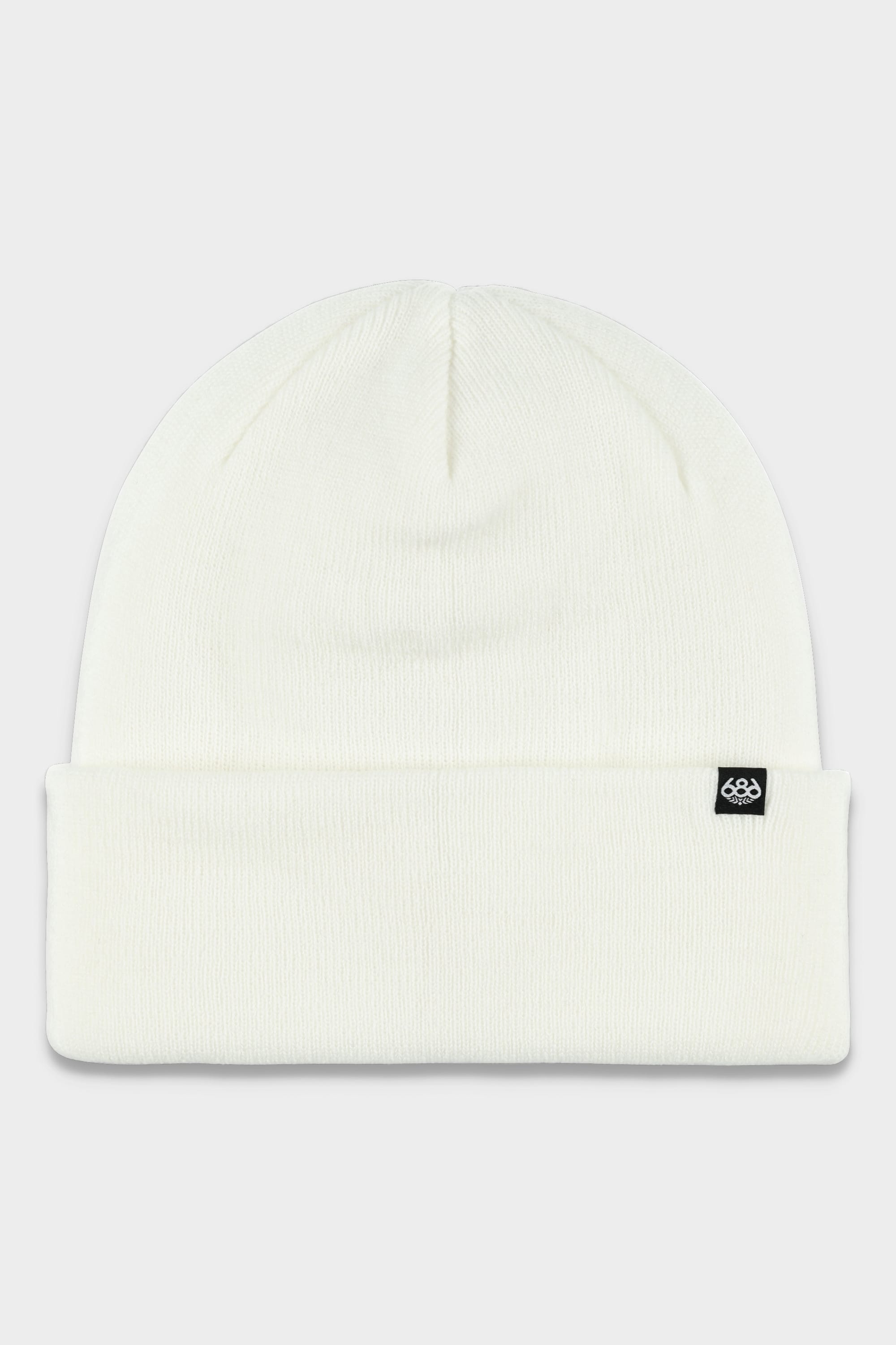 The 686 Standard Roll Up Beanie by 686 is a plain white knit beanie featuring a folded brim and a small black tag with a white logo on the front right side.