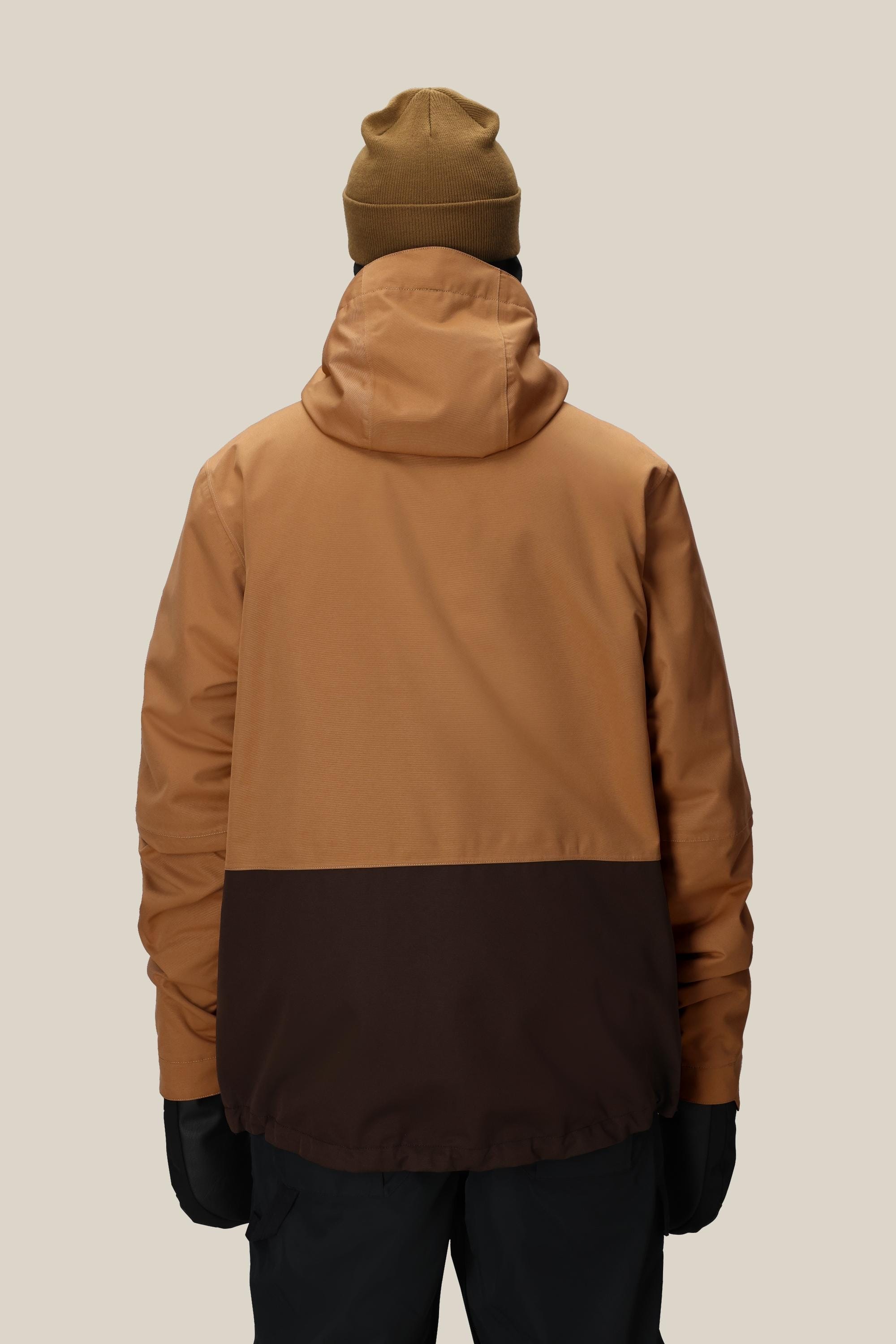 A person faces away against a plain light background, wearing the 686 Mens Smarty 3-In-1 Form Jacket by 686, paired with a brown beanie, black gloves, and dark pants.