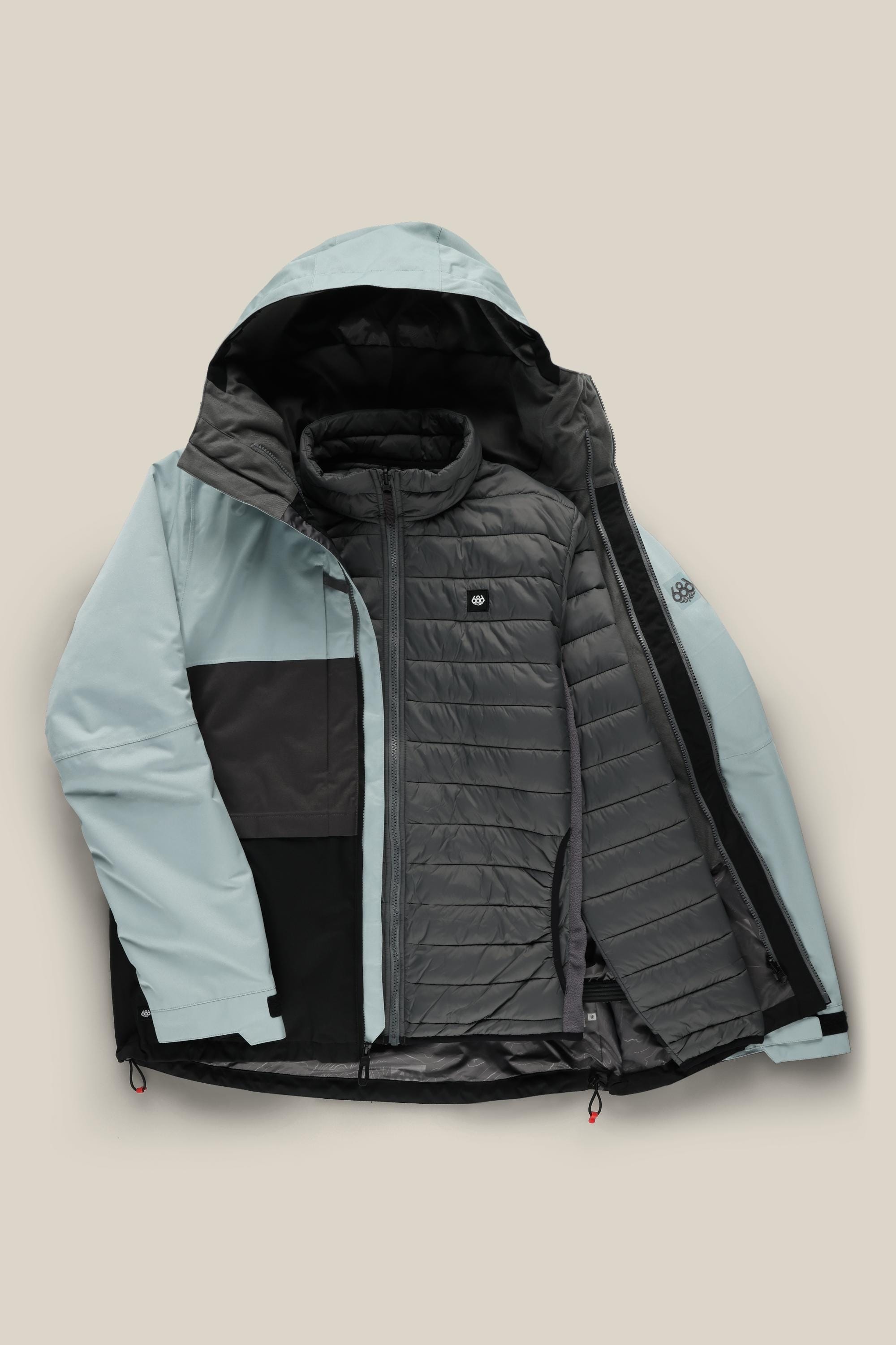 The 686 Mens Smarty 3-In-1 Form Jacket by 686 is shown in light blue and black, displayed open to reveal a removable quilted gray inner layer, both with front zippers, set against a plain beige background.