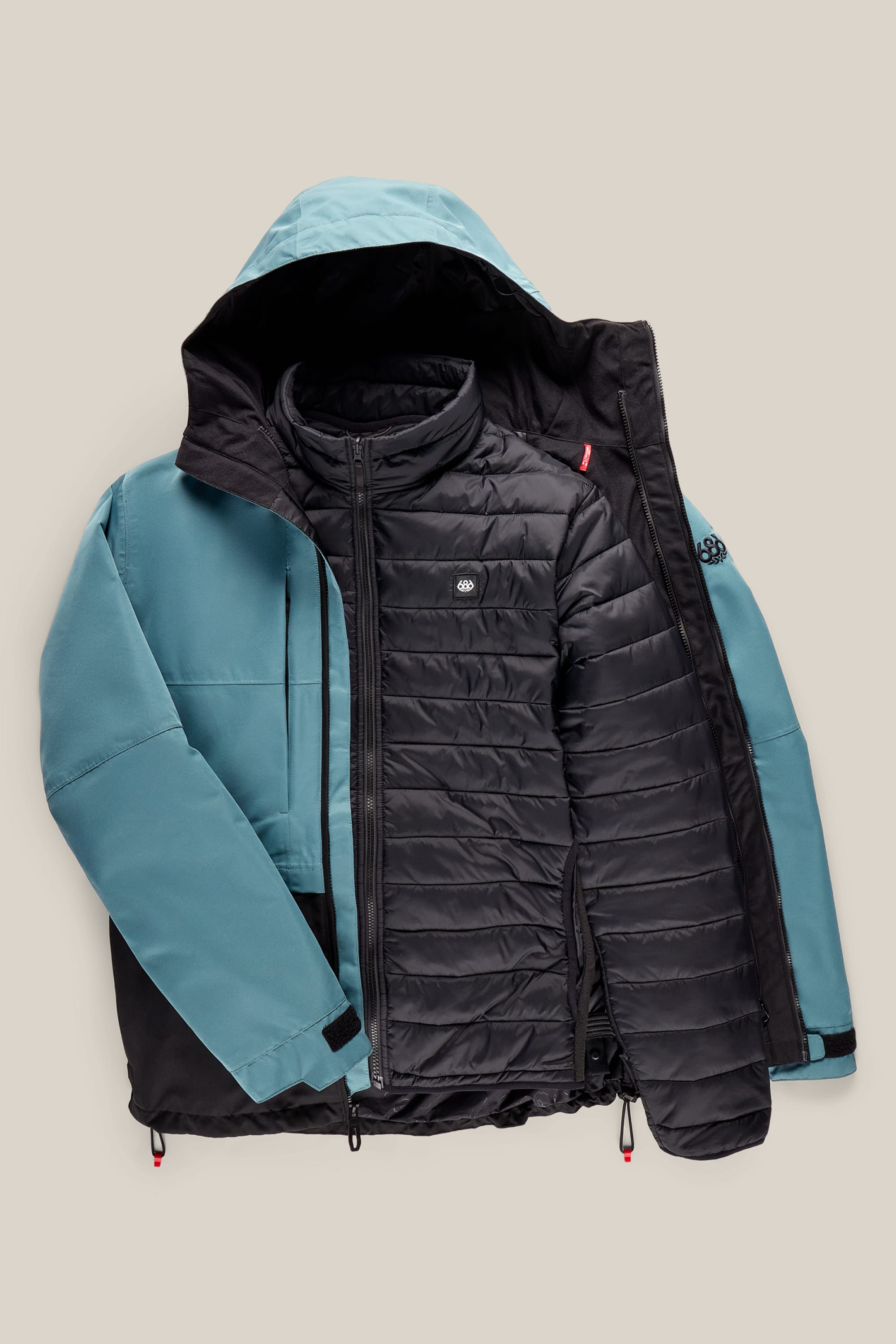 The 686 Men’s SMARTY® 3-In-1 Form Jacket by 686 features a two-tone design with a light blue outer shell and a quilted black inner layer, shown partially unzipped to display both layers. The jacket includes a blue hood and is finished with a small logo on the chest.
