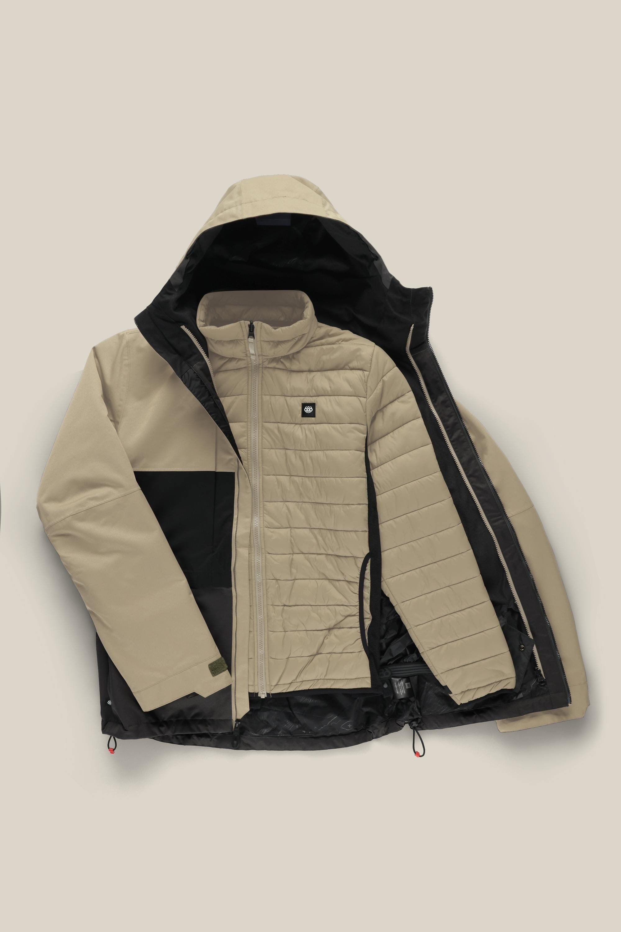 The 686 Mens Smarty 3-In-1 Form Jacket by 686, shown in beige and black, features a waterproof design with a quilted inner lining. Displayed partially unzipped against a neutral background, it highlights its interior and zippered side pockets.