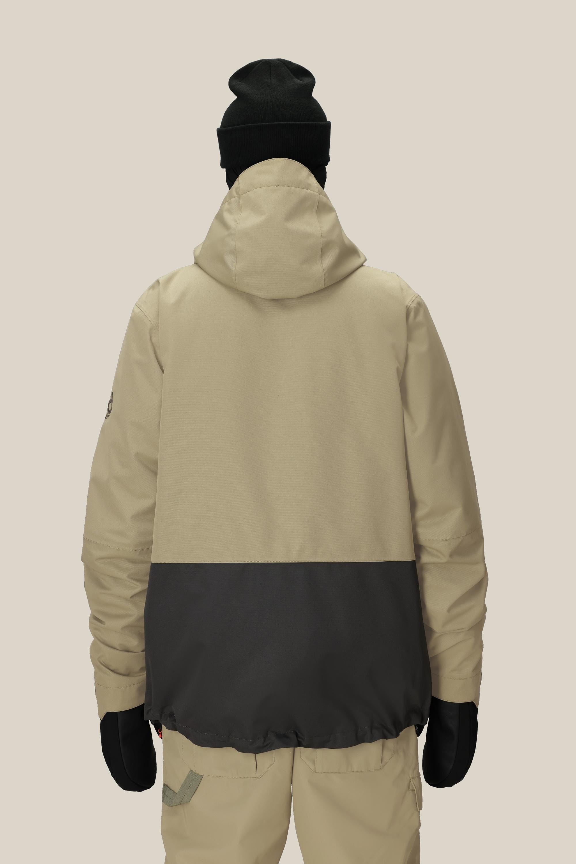 A person is shown from the back, wearing the 686 Mens Smarty 3-In-1 Form Jacket in beige and black with a hood, paired with beige pants, black gloves, and a black beanie against a plain light background.