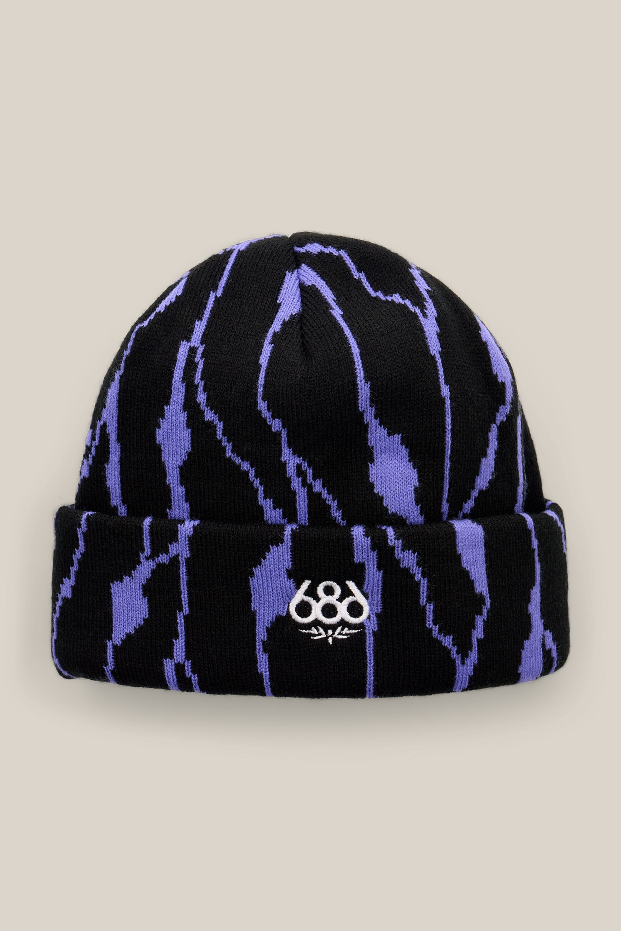 The 686 Women’s Cepa Beanie features black acrylic knit construction with a bold purple abstract zigzag pattern and a white embroidered 686 logo on the front fold. Designed by 686, this stylish beanie stands out beautifully against a plain beige background—making it the perfect accessory for women.