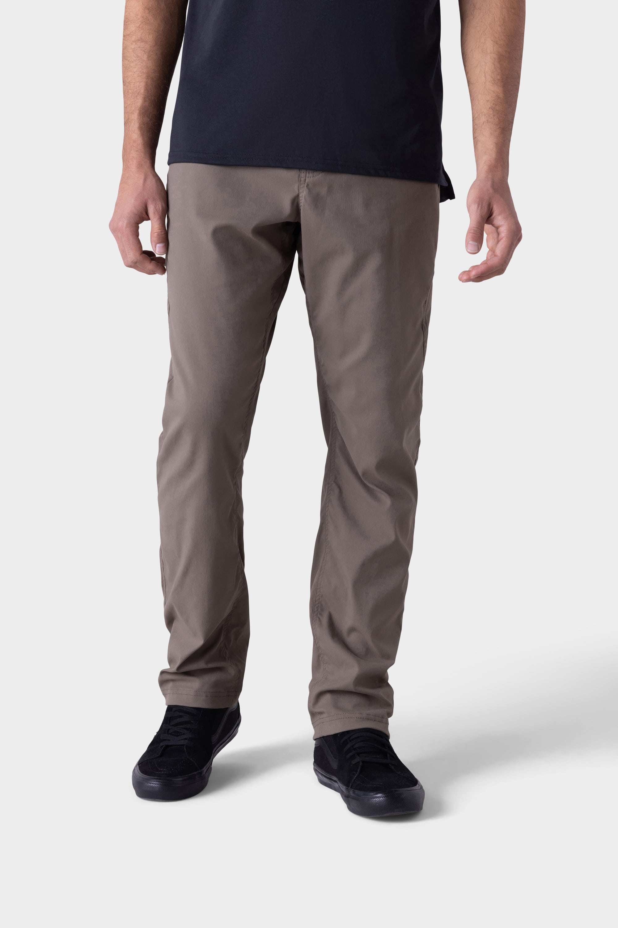 A person wearing 686 Mens Platform Bike Pant - Relaxed Fit in taupe stands against a plain light grey background, with only the lower half of the body visible.