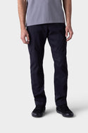 A person models the 686 Mens Platform Bike Pant - Relaxed Fit by 686, paired with a grey short-sleeve shirt and black shoes, standing against a light background. Only their lower torso, legs, and hands are visible; face is not shown.