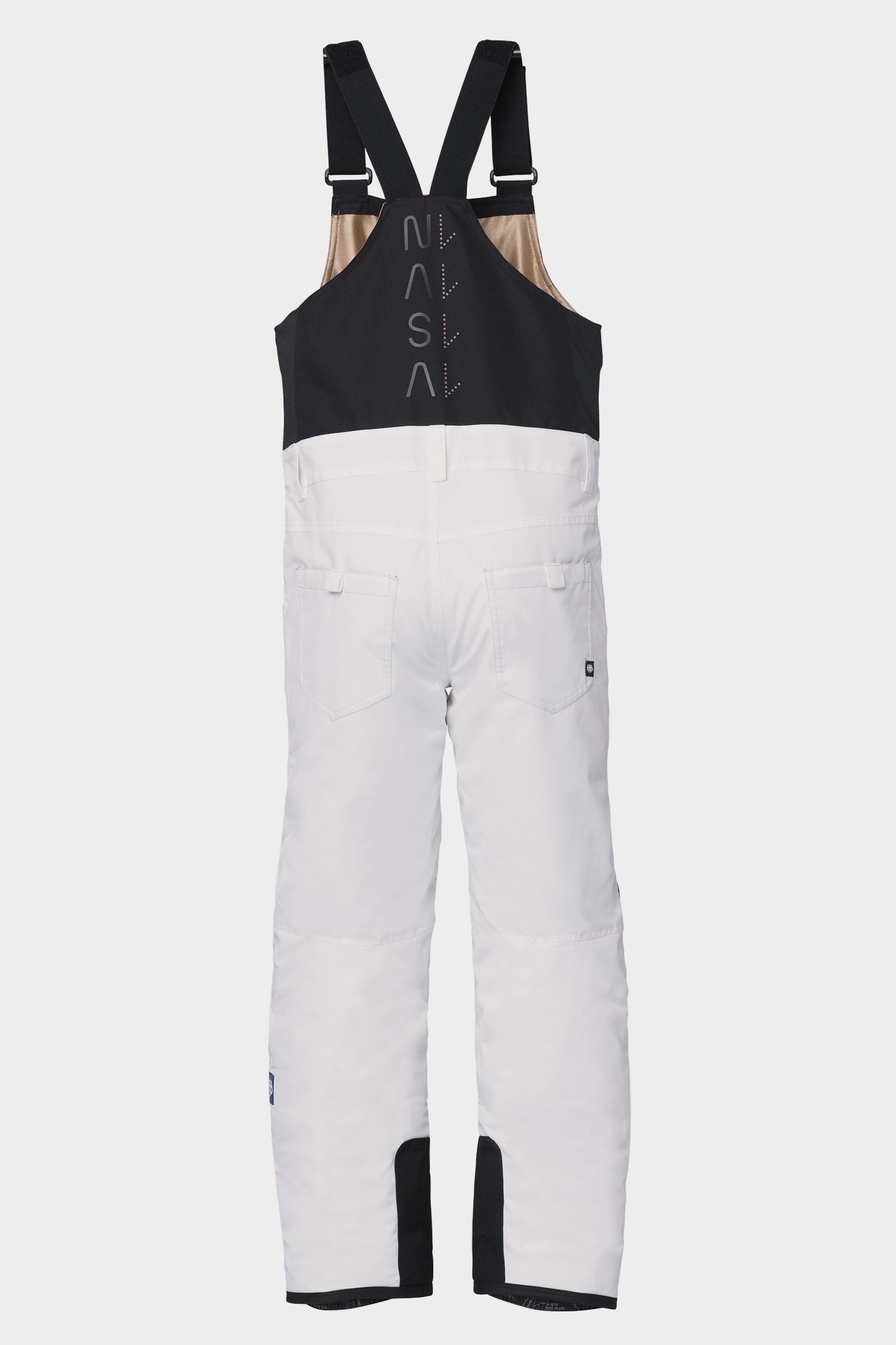 The 686 Youth Exploration Insulated Bib by 686 features white snow bib pants with black adjustable shoulder straps, a black upper section, vertical NASA print on the back, two back pockets, and reinforced black patches on the lower legs.