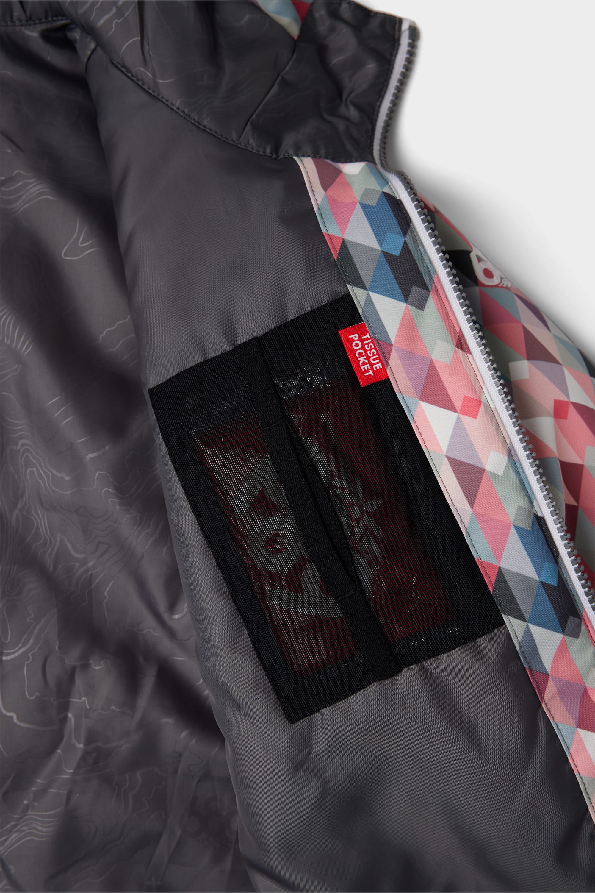 The inside of the 686 Youth Exploration Insulated Jacket reveals a mesh pocket with a red PASSHOLDER POCKET tag, subtle map print lining, and colorful geometric patterns near the zipper.