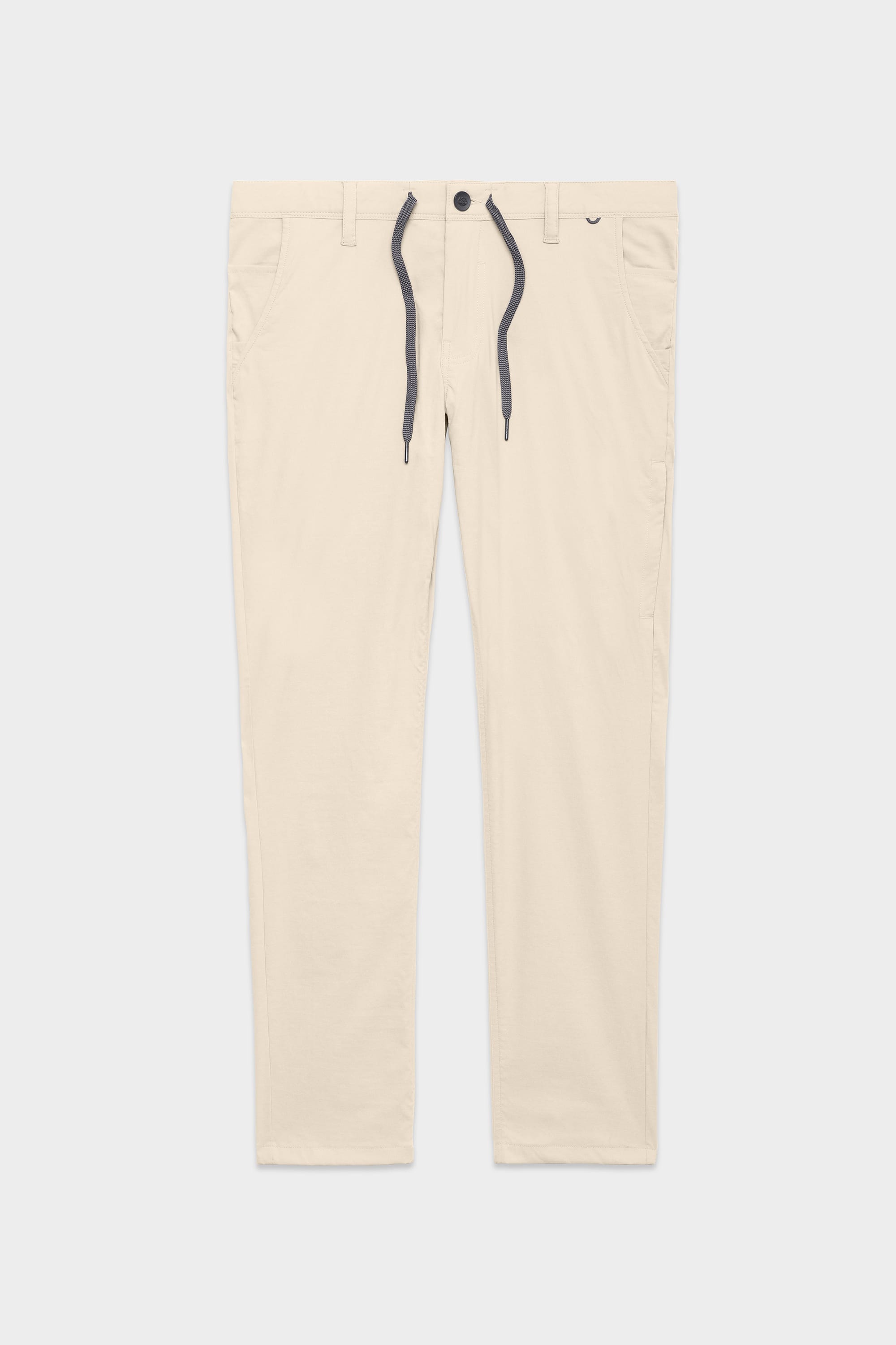The 686 Mens Everywhere Featherlight Chino Pant - Slim Fit features a beige color, front button, zip fly, side pockets, and a grey drawstring waist—ideal for summer style or warm weather adventures. Shown laid flat on a white background.