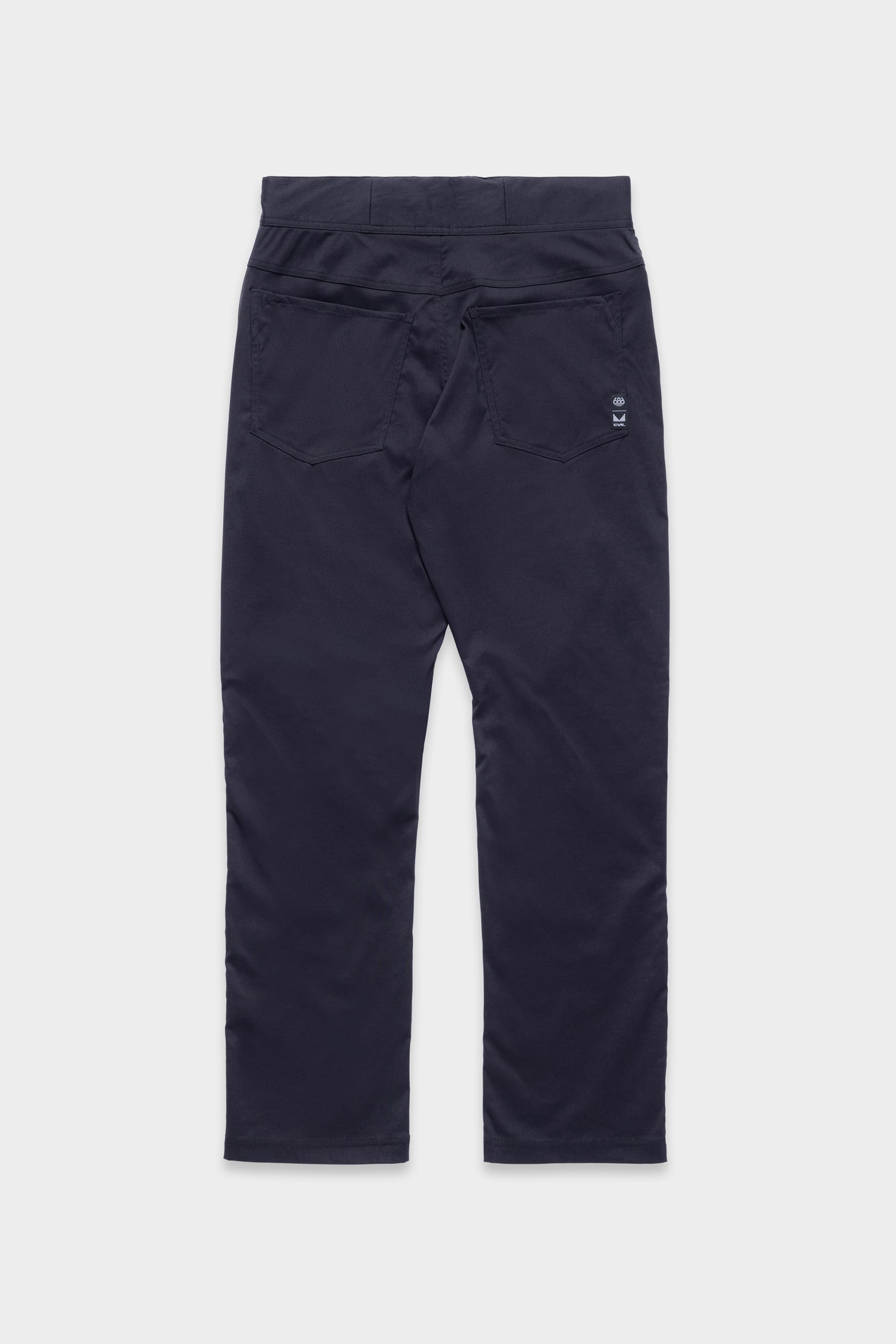 The 686 Mens Platform Bike Pant - Relaxed Fit, shown in navy blue and laid flat on a white background, features two back pockets and a small embroidered logo above the right pocket.