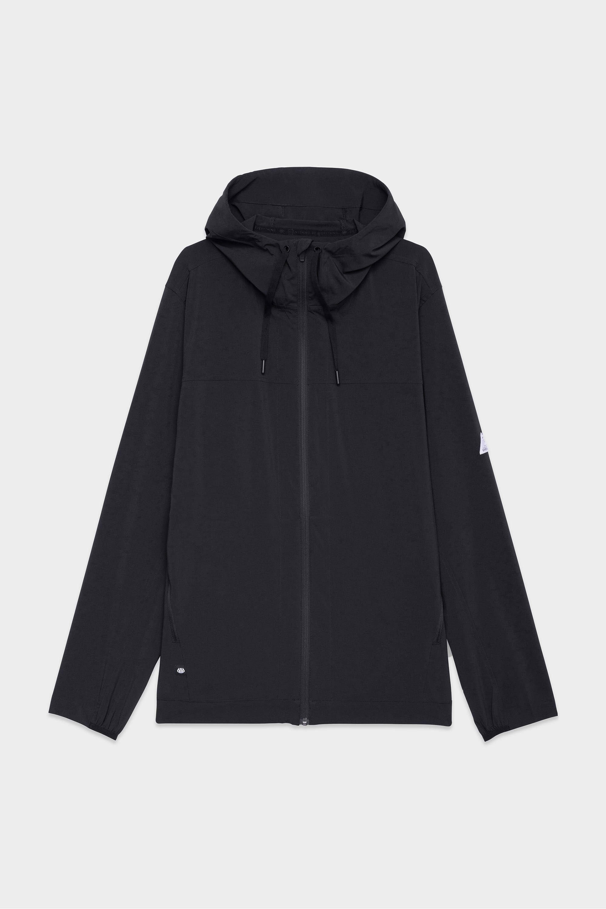 The 686 Mens ATP Stretch Wind Jacket by 686 features a black design with long sleeves, front zipper, hood drawstrings, and a small left sleeve tag, shown on a plain white background.