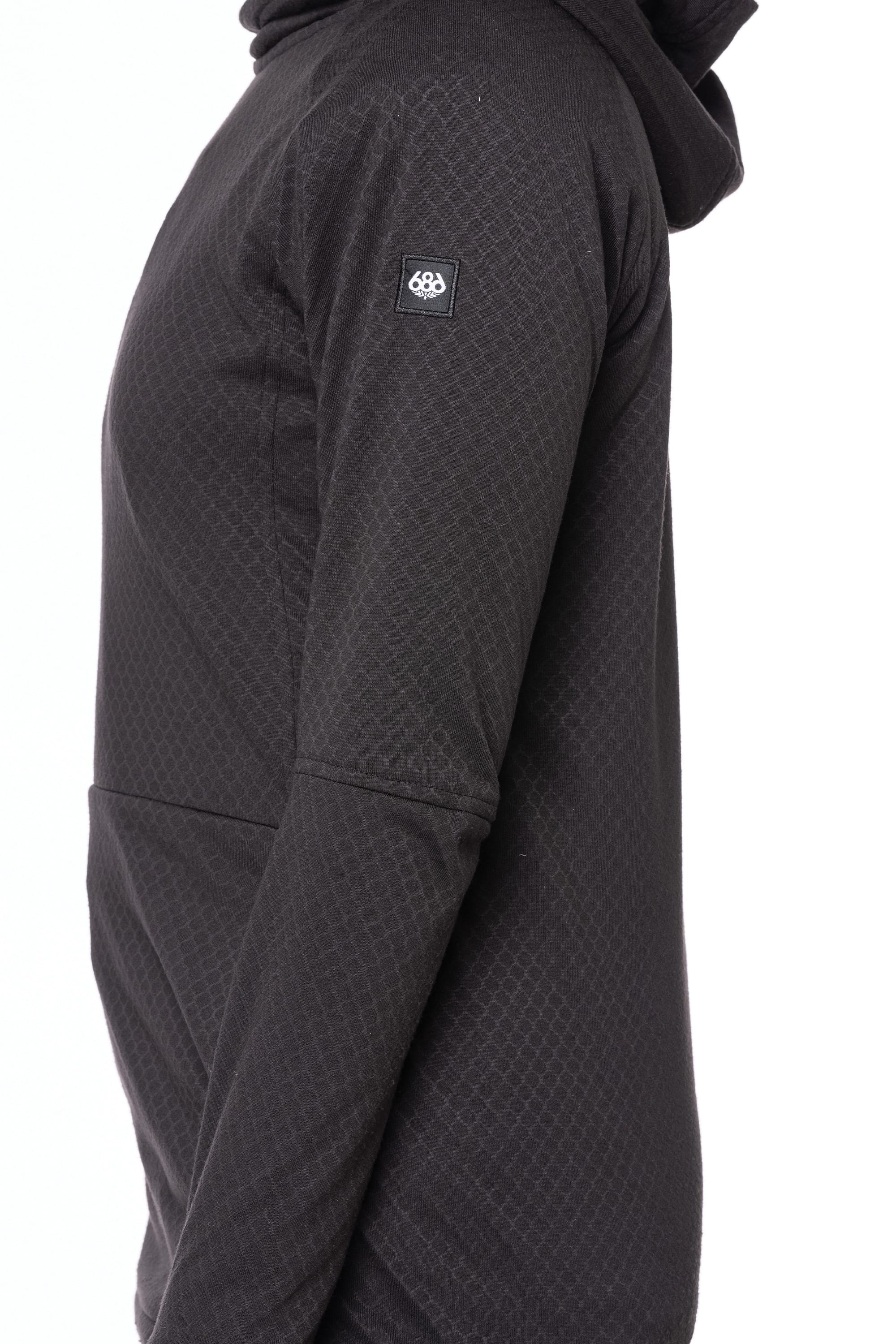 A woman wearing the 686 Womens Mission Grid Fleece Hoody in black, featuring a small square logo patch on the upper sleeve, is shown from the side against a white background.