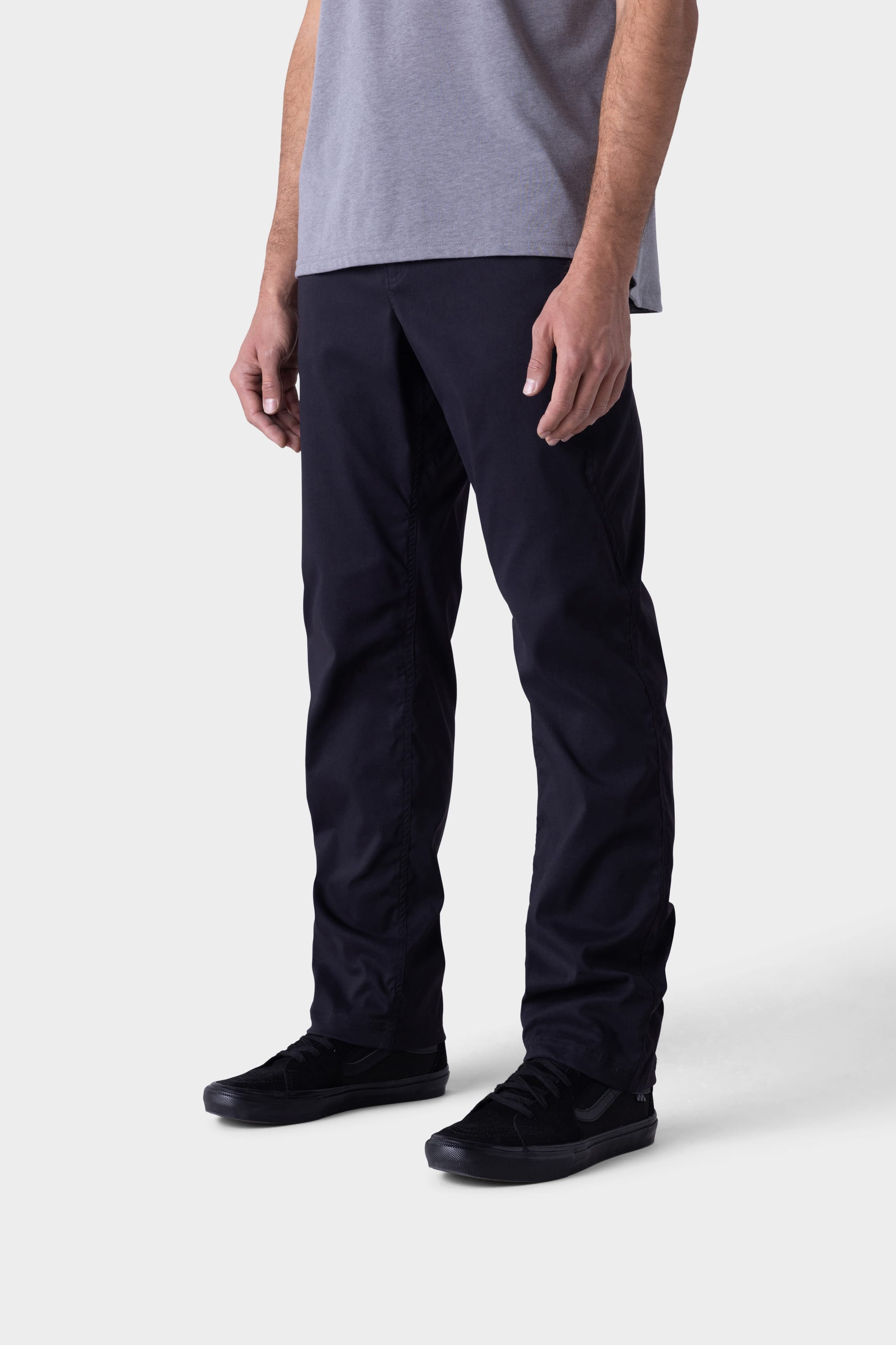 A person is shown from the lower torso down, wearing 686 Mens Platform Bike Pant - Relaxed Fit in black; the image features only their legs, arms, and waist against a plain white background.