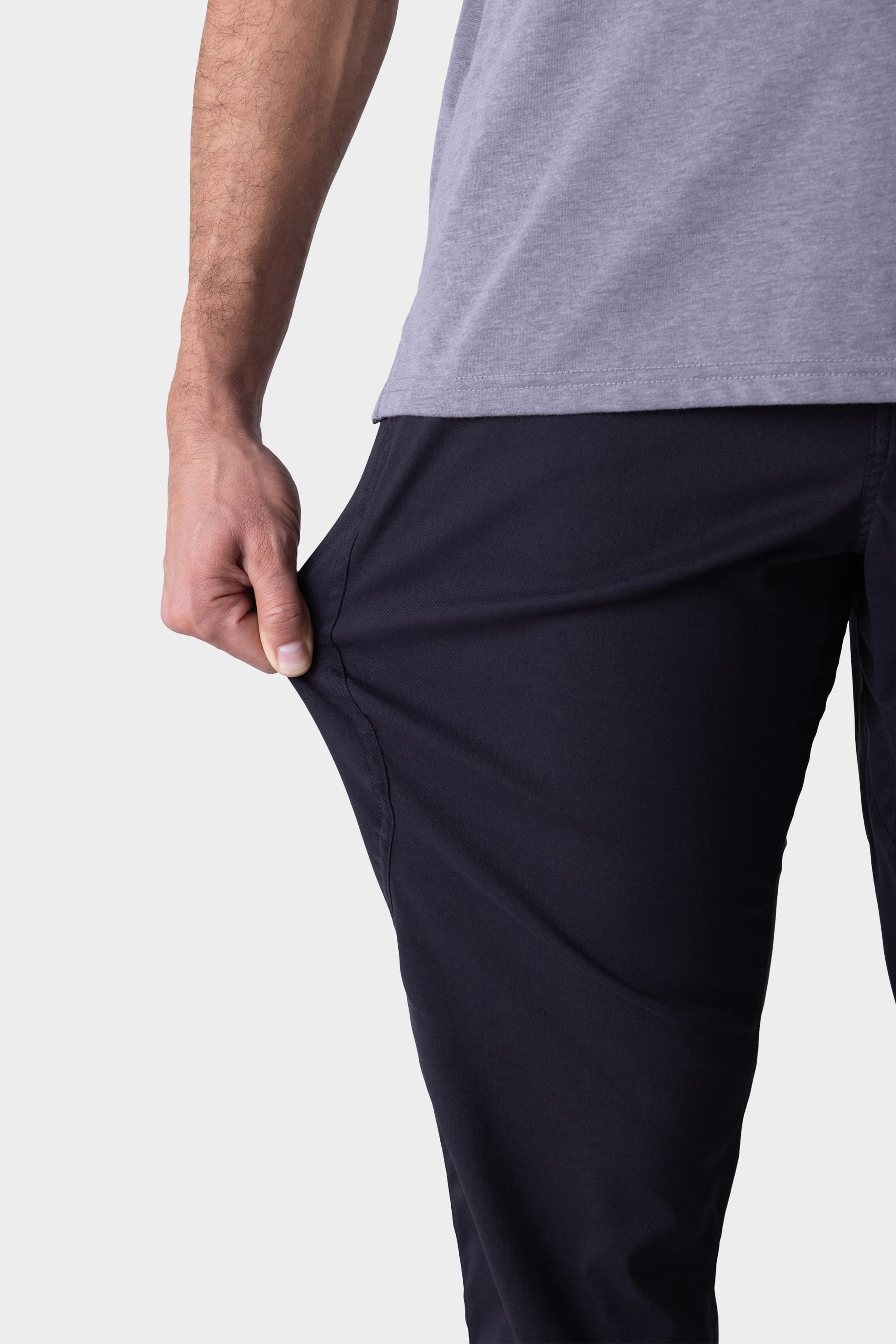 A person wearing the 686 Mens Platform Bike Pant - Relaxed Fit demonstrates its stretchy material by pulling the fabric outward with one hand.